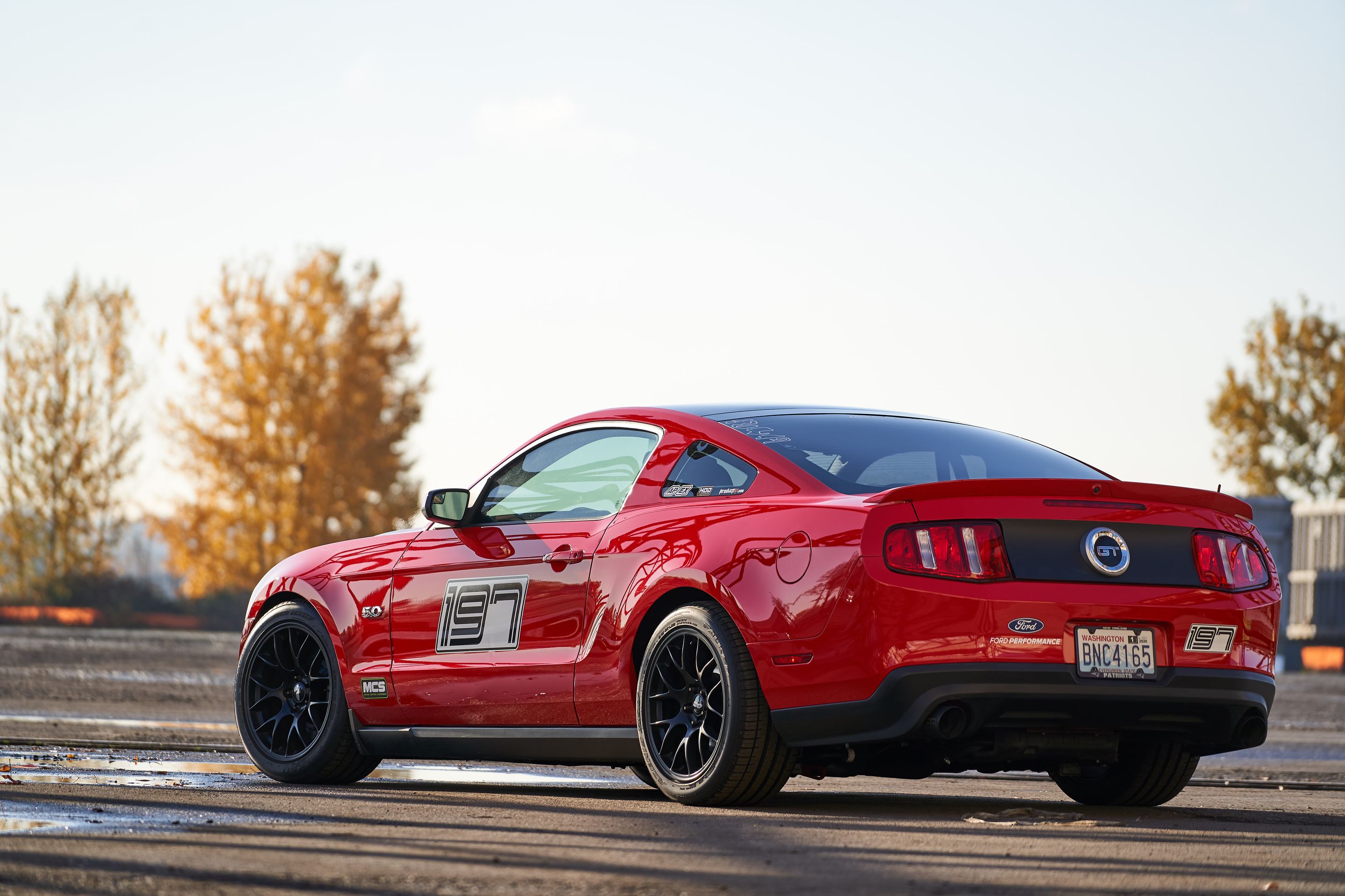 Red Ford S197 Mustang GT with 18" EC-7 Apex wheels in Satin Black