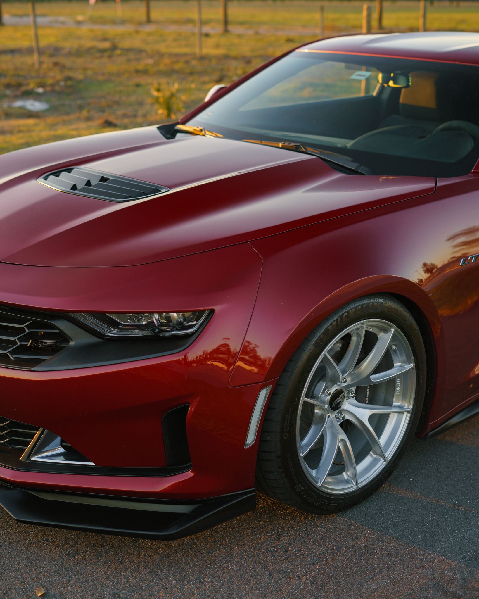 Red Chevrolet 6th Gen Camaro LT1 with 19" VS-5RS Apex wheels in Brushed Clear