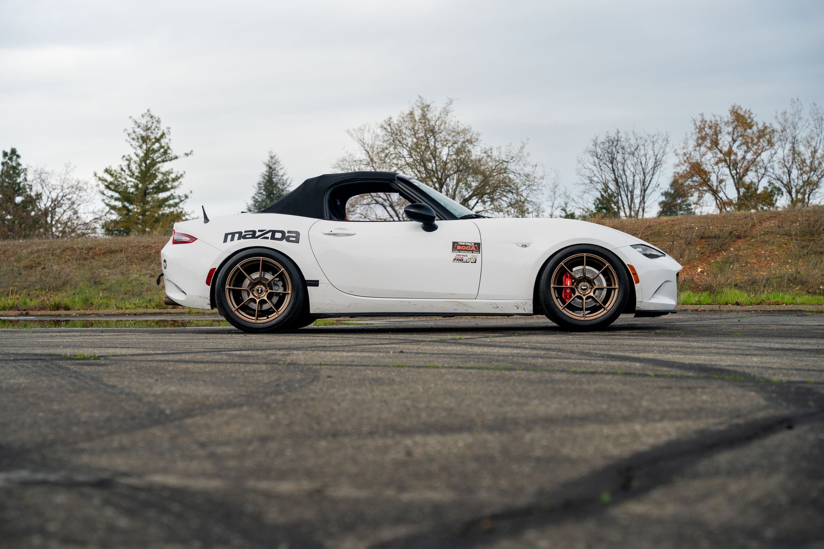 White Mazda ND MX-5 Miata with 17" SM-8RS Apex wheels in Satin Bronze