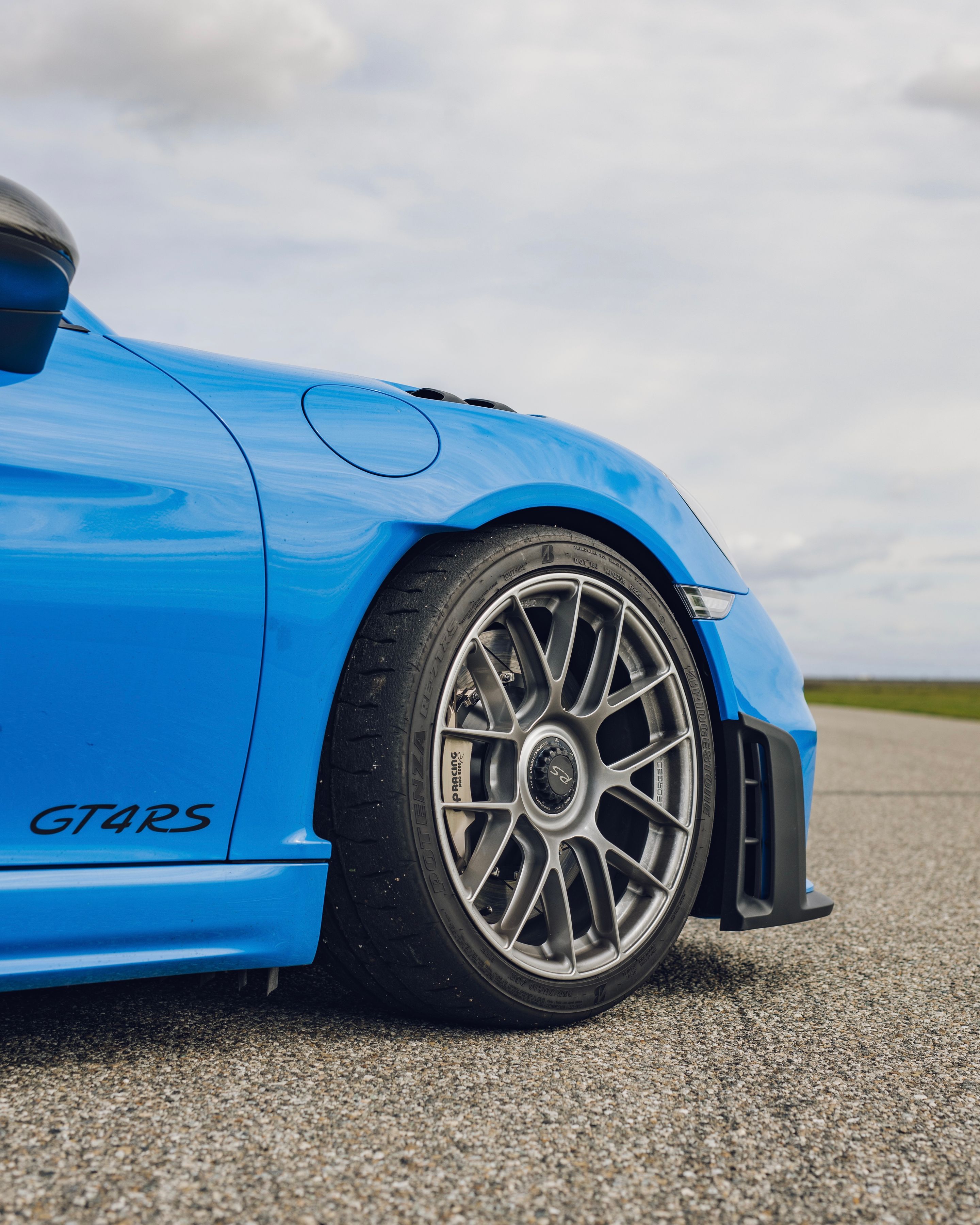 Blue Porsche 718 Cayman GT4 RS with 19" EC-7RS Apex wheels in Race Silver