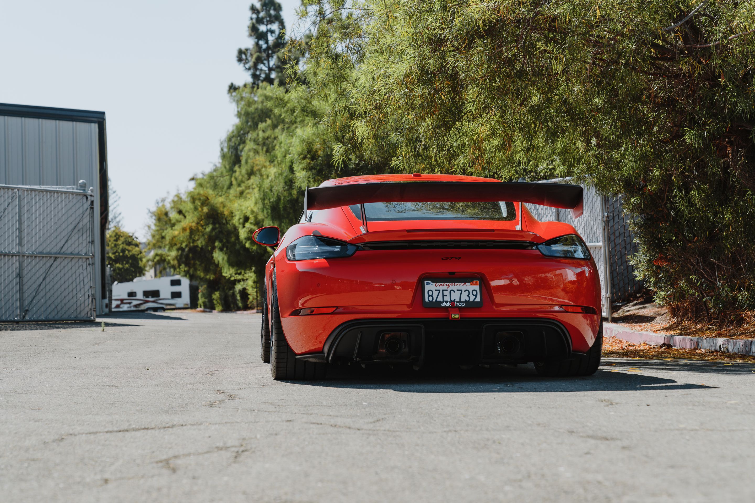 Red Porsche 718 Cayman GT4 with 19" VS-5RS Apex wheels in Satin Black