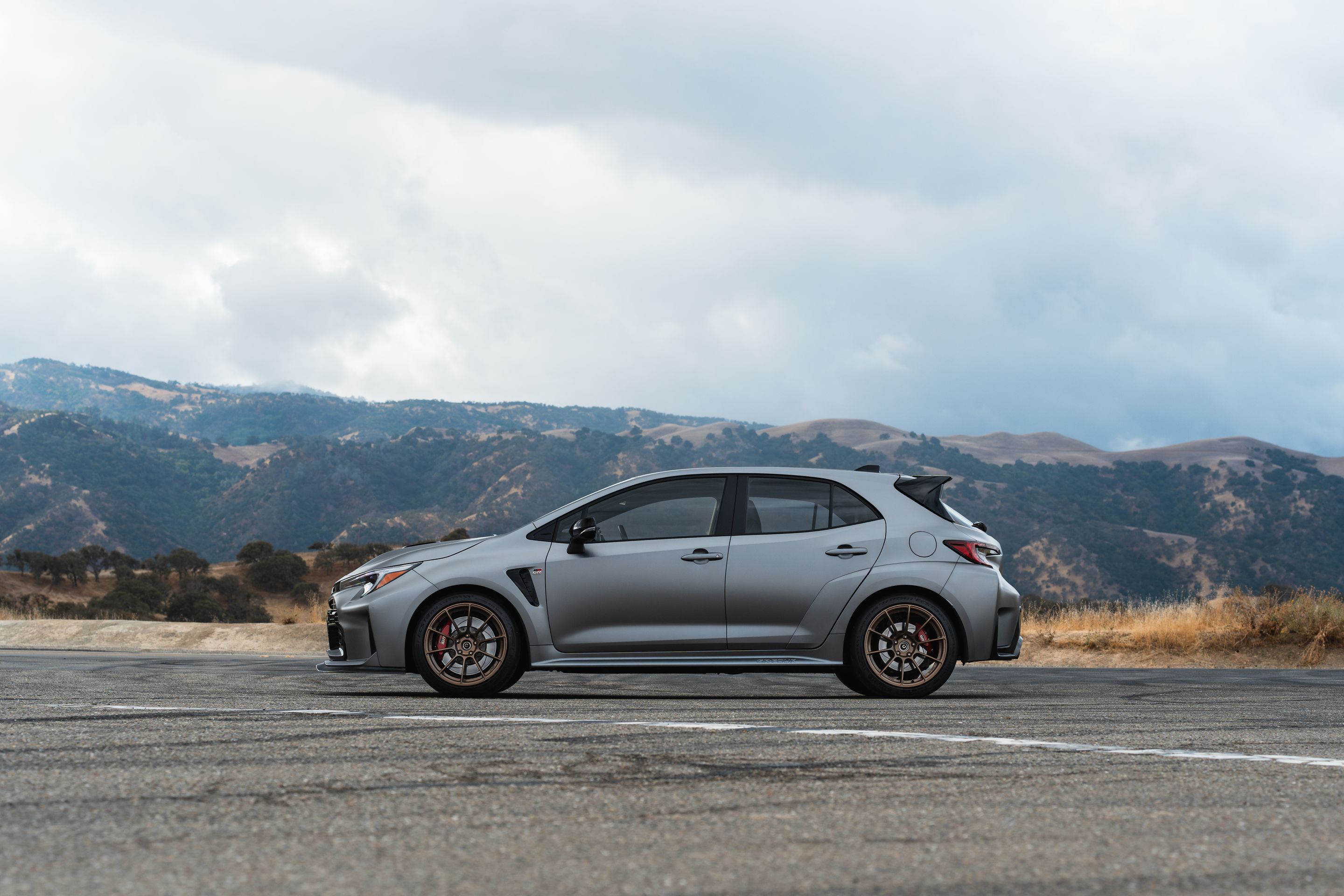 Grey Toyota GR Corolla with 18" SM-10RS Apex wheels in Satin Bronze