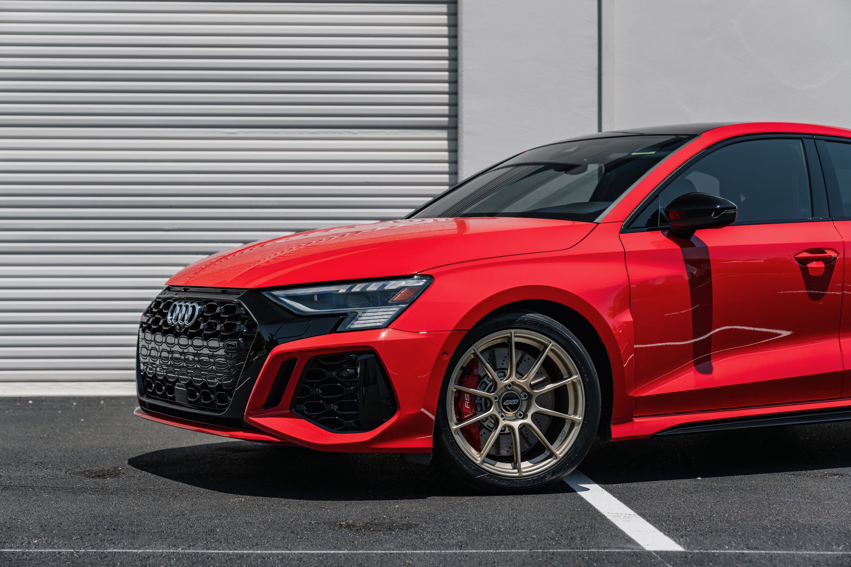 Red Audi 8Y RS 3 with 18" SM-10RS Apex wheels in Motorsport Gold