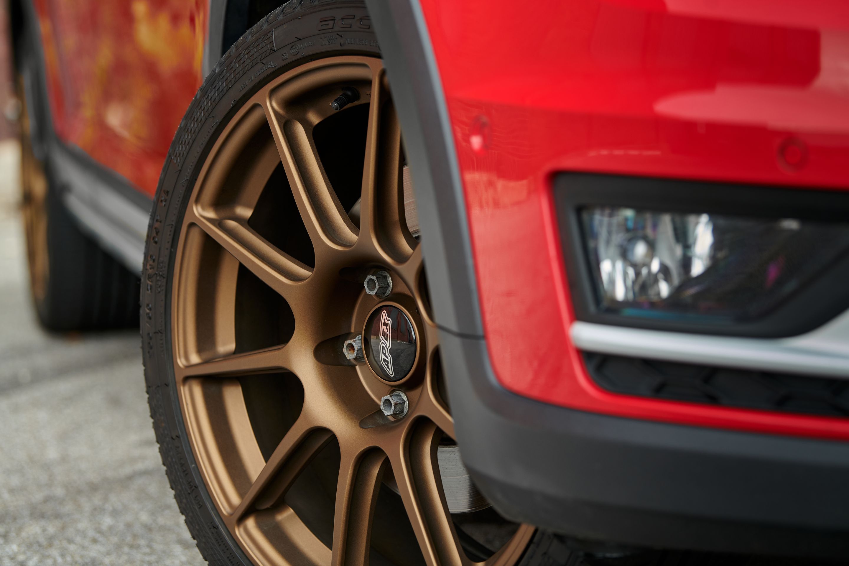 Red VW MK7 Alltrack/SportWagen Alltrack with 18" SM-10 Apex wheels in Satin Bronze