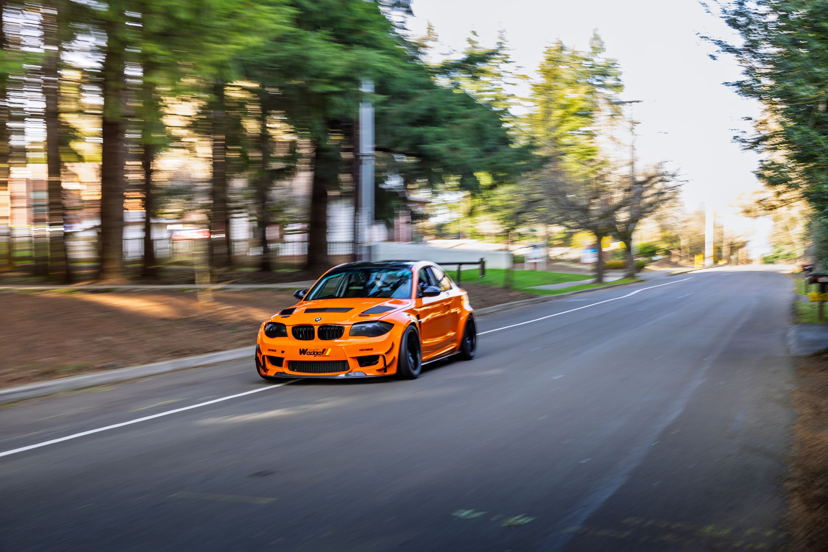 Orange BMW E82 1M with 18" EC-7 Apex wheels in Satin Black