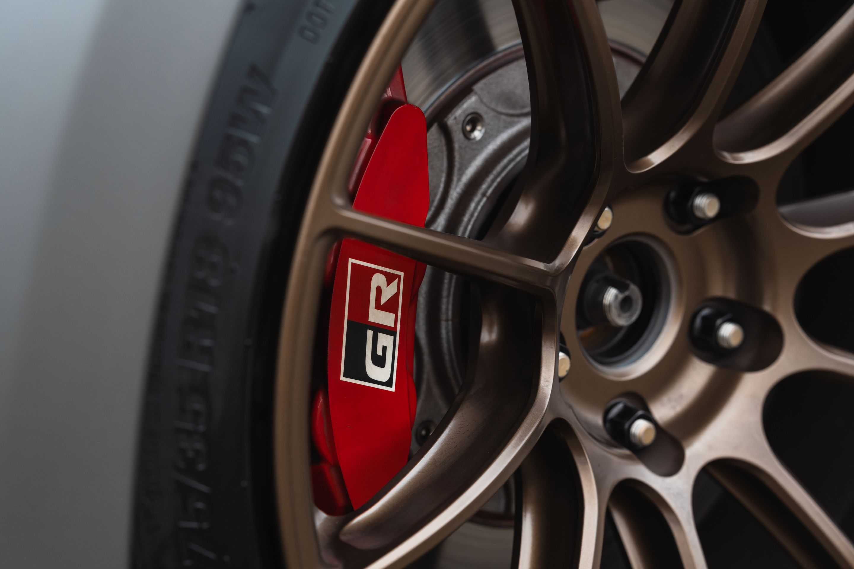 Grey Toyota GR Corolla with 18" SM-10RS Apex wheels in Satin Bronze