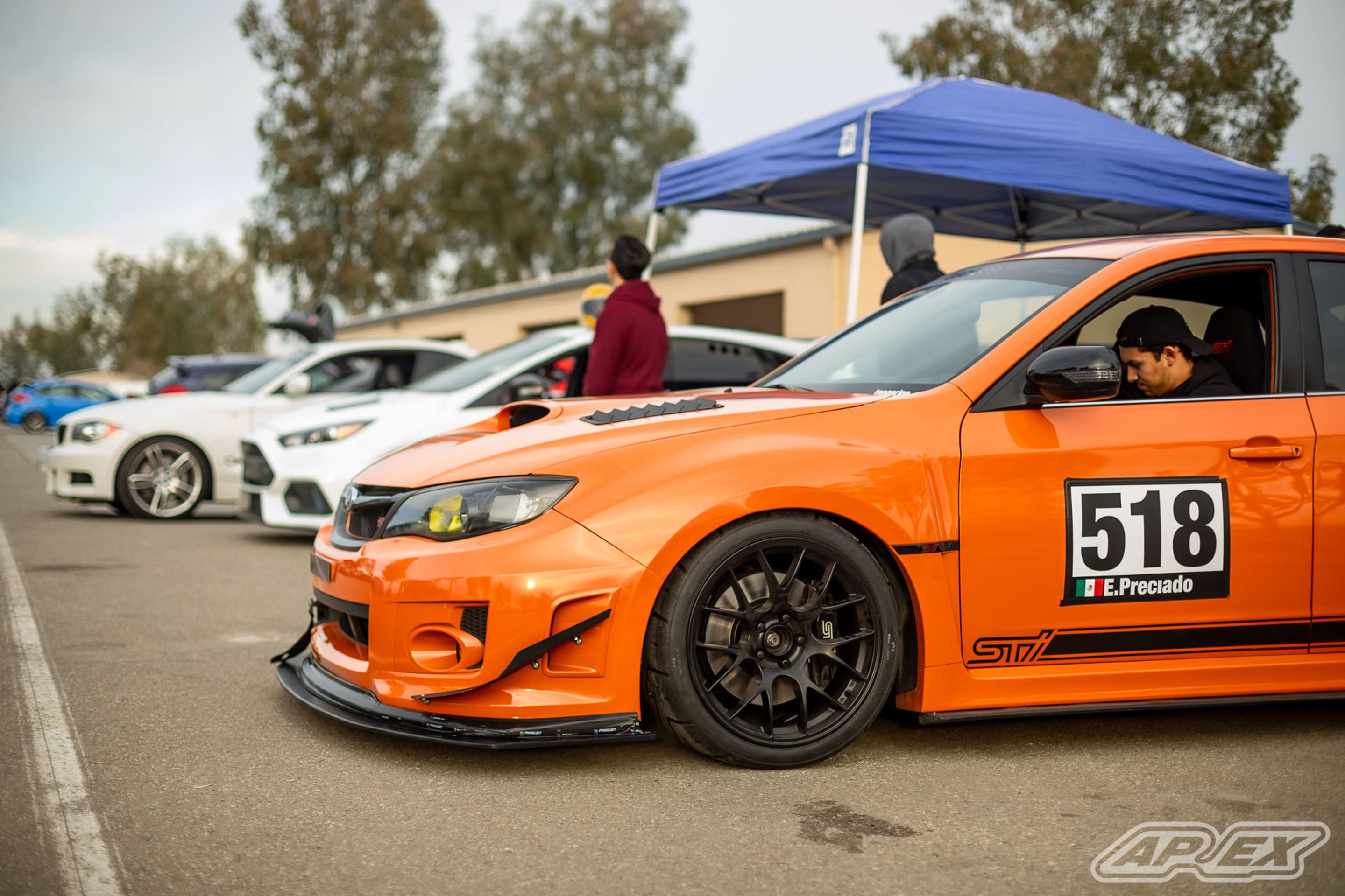 Orange Subaru GR WRX STI with 18" EC-7 Apex wheels in Satin Black