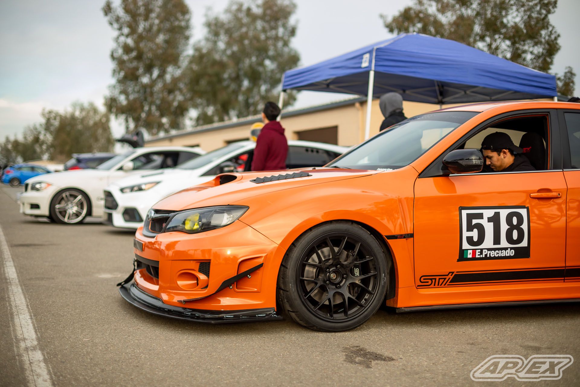 Orange Subaru GR WRX STI with 18" EC-7 Apex wheels in Satin Black