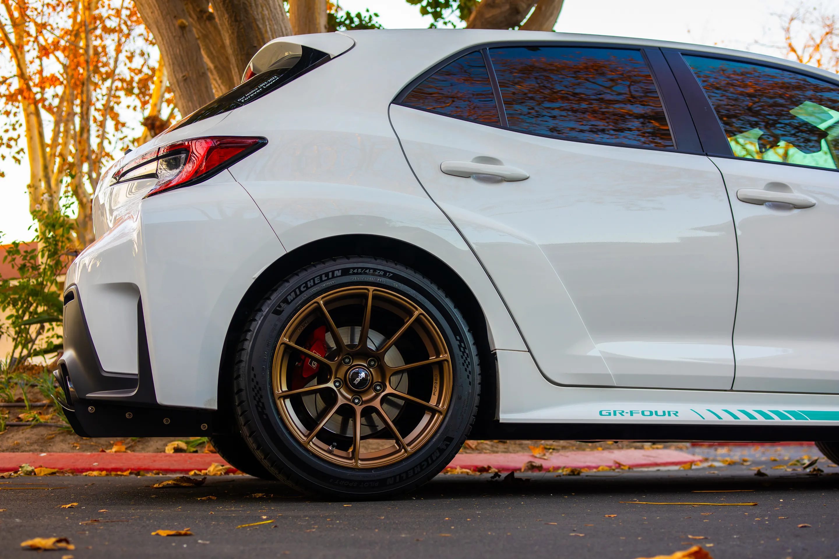 White Toyota GR Corolla with 17" SM-10RS Apex wheels in Satin Bronze