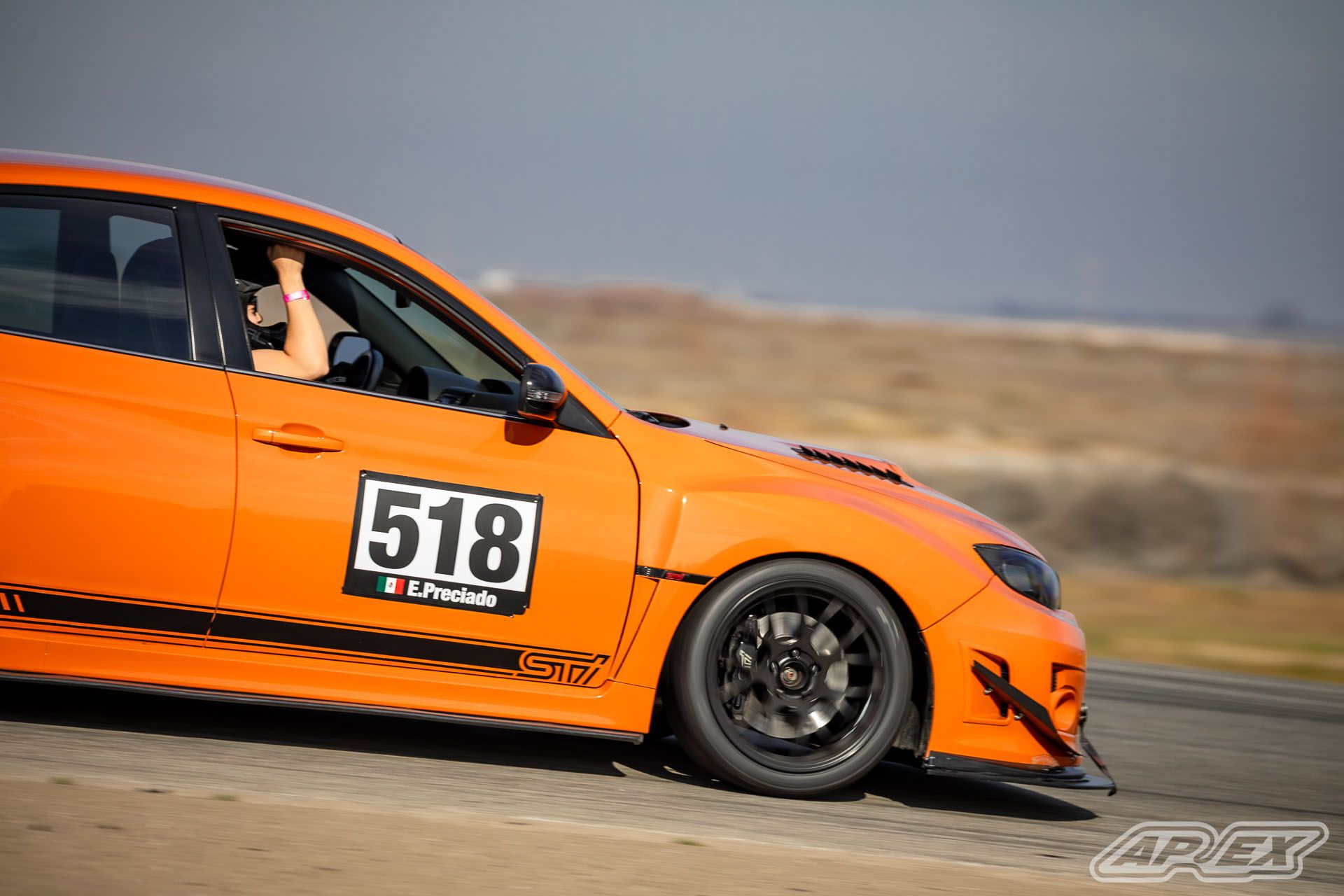 Orange Subaru GR WRX STI with 18" EC-7 Apex wheels in Satin Black