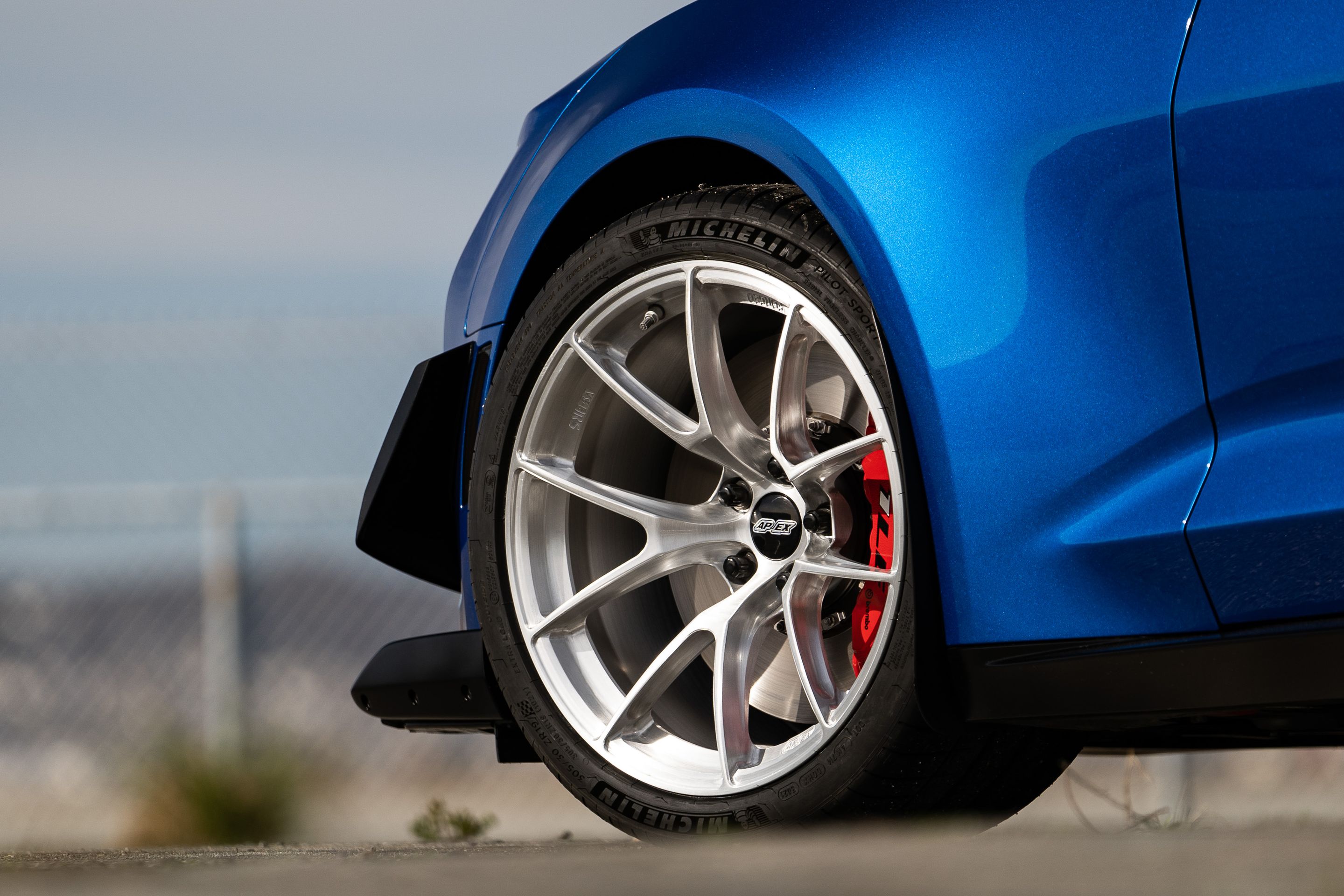 Blue Chevrolet 6th Gen Camaro ZL1 1LE with 19" VS-5RS Apex wheels in Brushed Clear