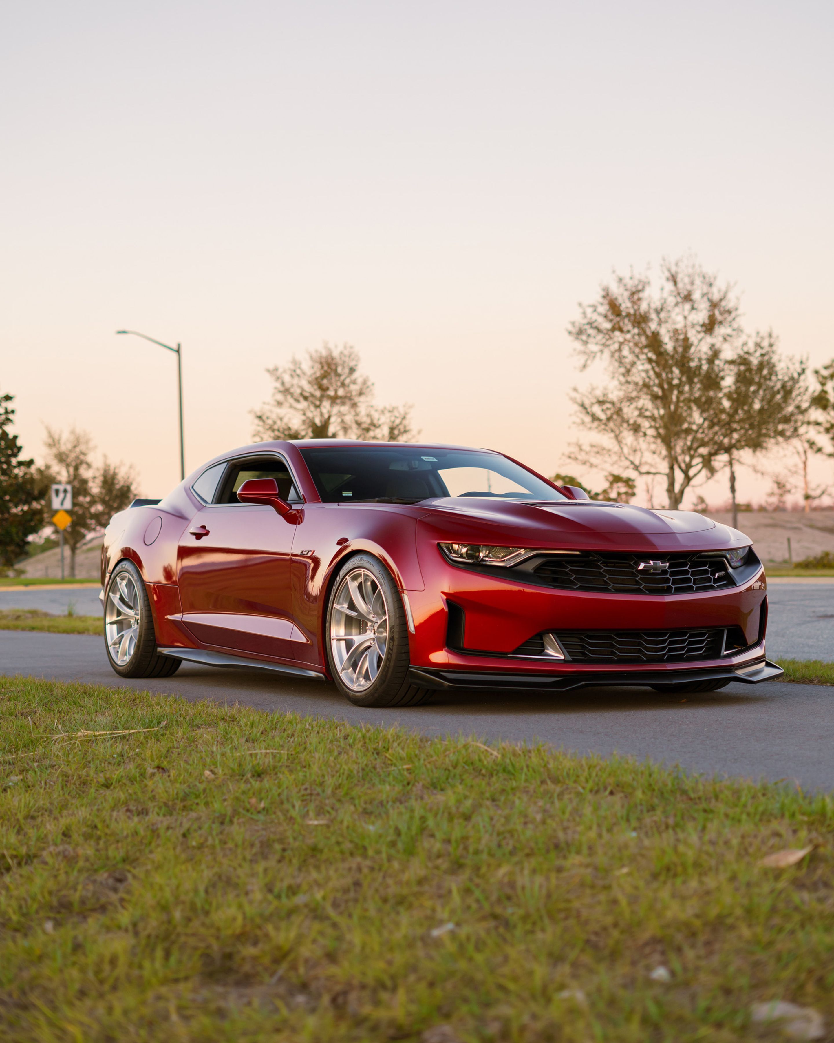 Red Chevrolet 6th Gen Camaro LT1 with 19" VS-5RS Apex wheels in Brushed Clear