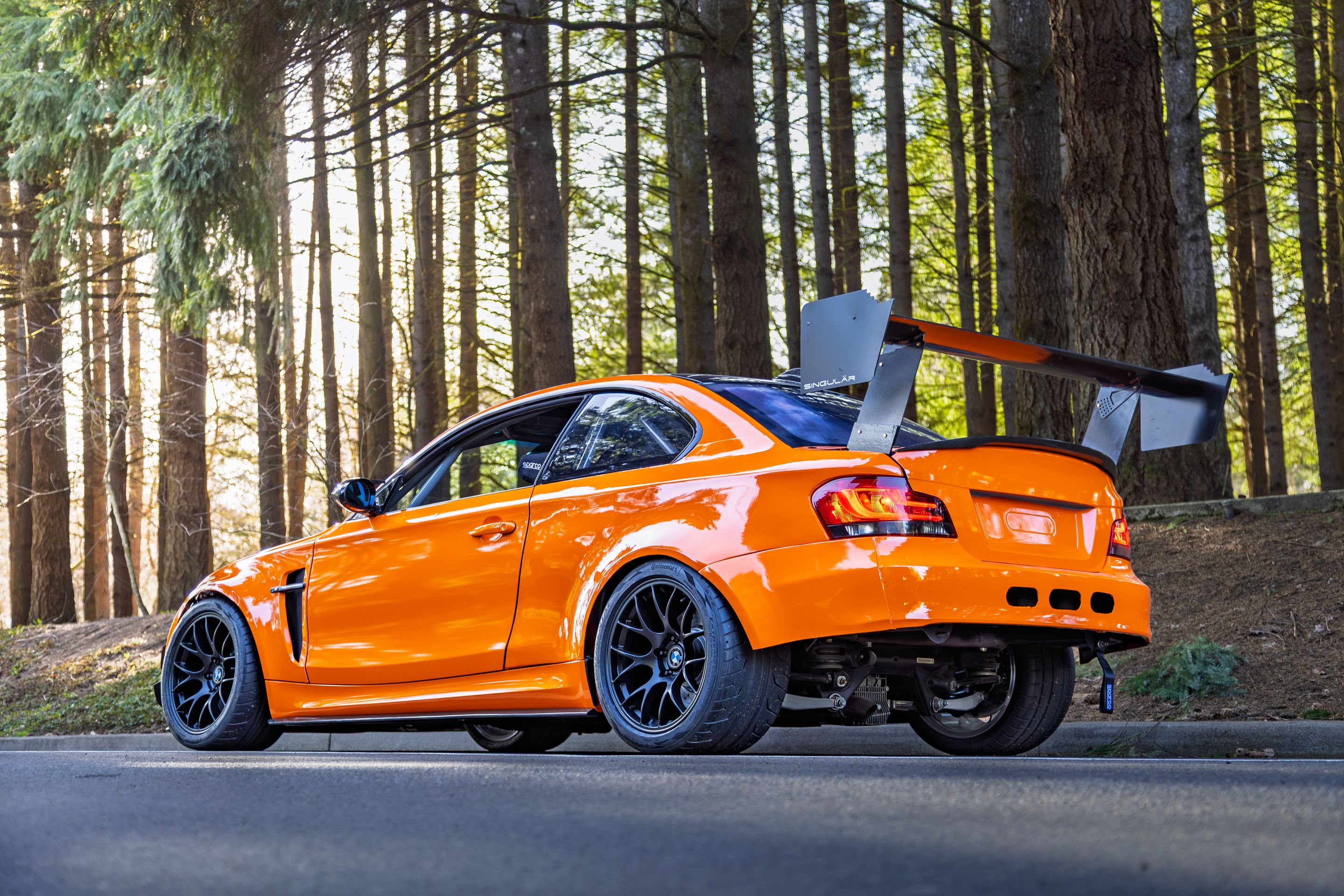 Orange BMW E82 1M with 18" EC-7 Apex wheels in Satin Black