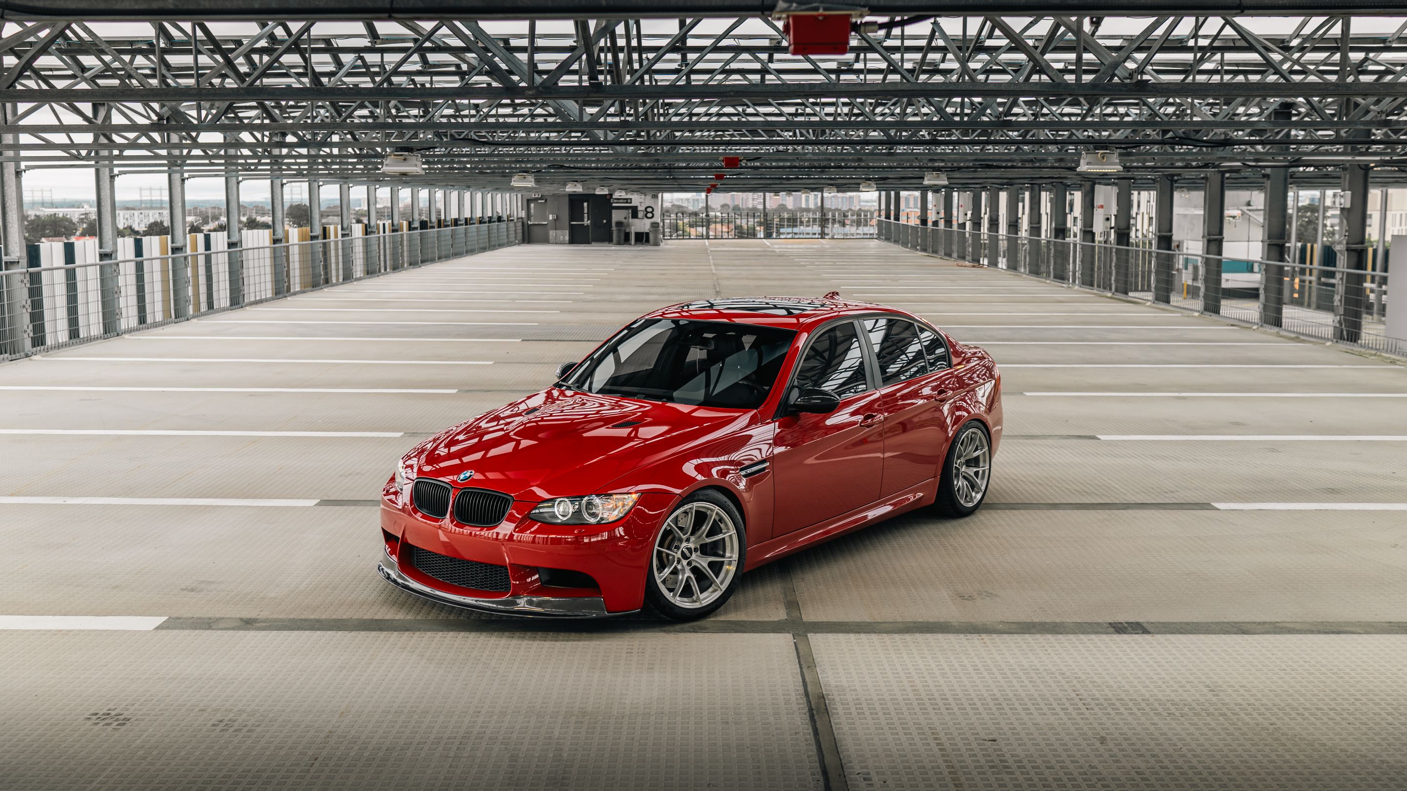 Red BMW E90 Sedan M3 with 18" VS-5RS Apex wheels in Brushed Clear