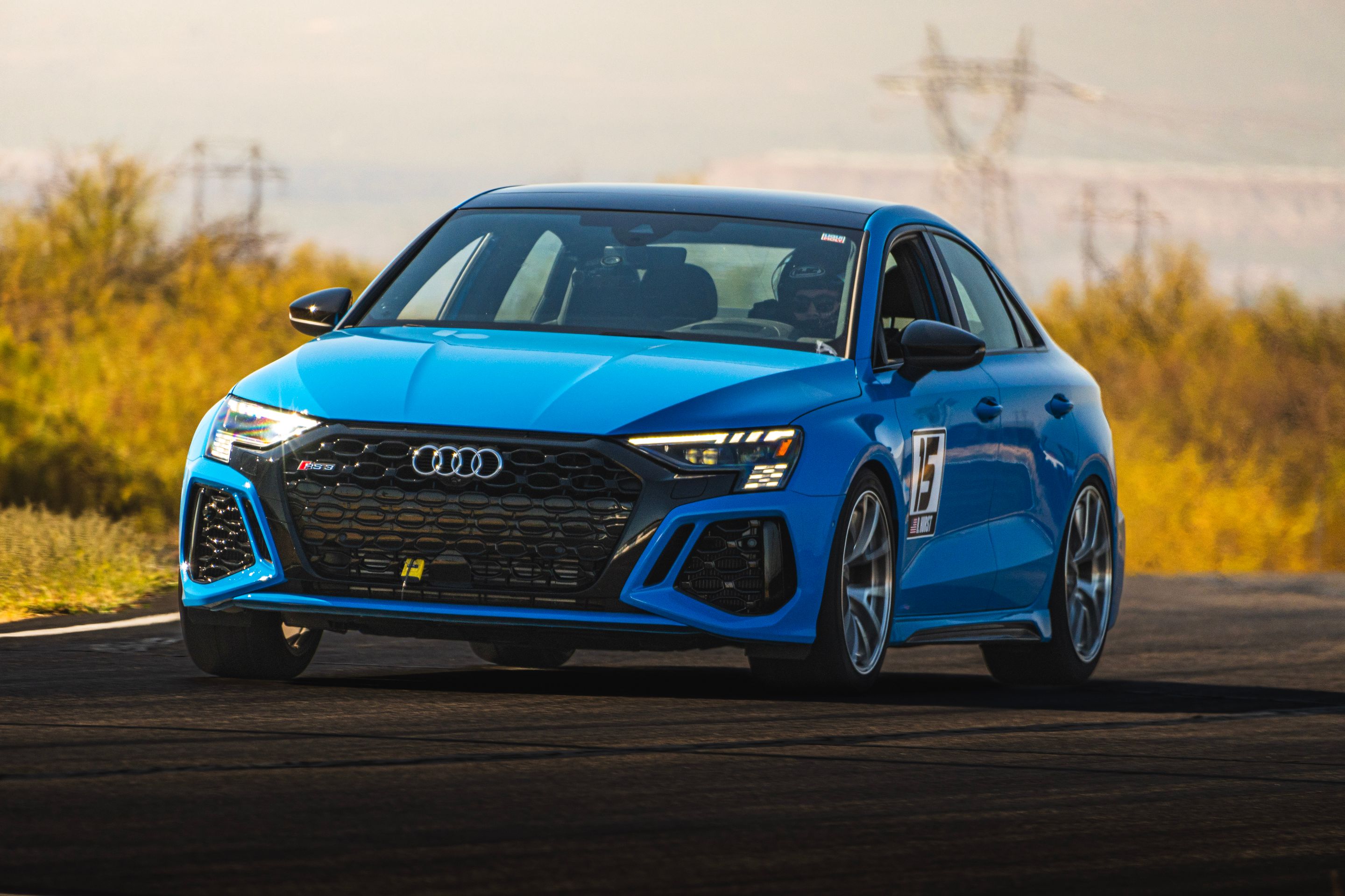 Blue Audi 8Y RS 3 with 18" VS-5RS Apex wheels in Brushed Clear