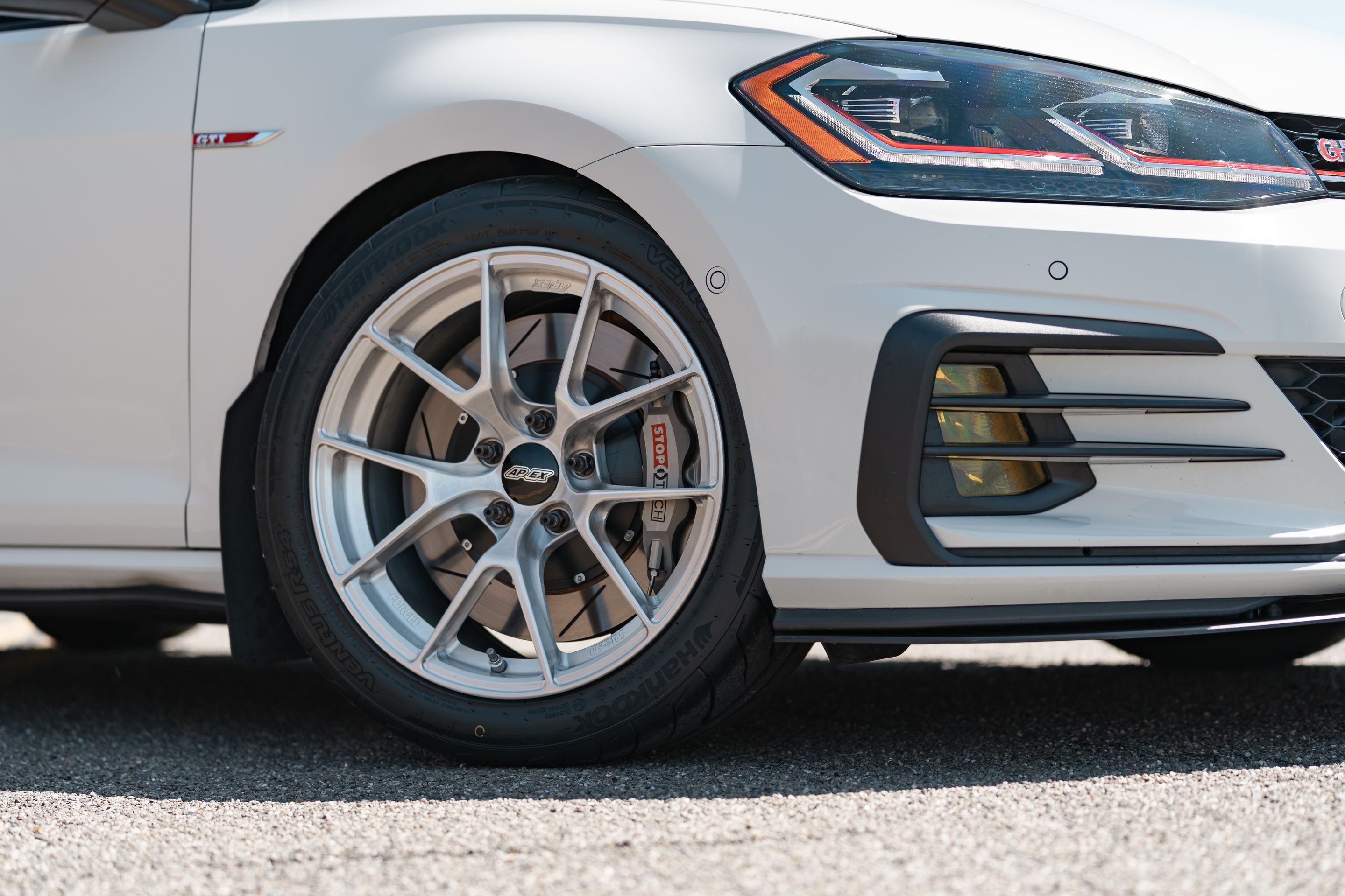 White VW MK7 GTI with 17" VS-5RS Apex wheels in Brushed Clear