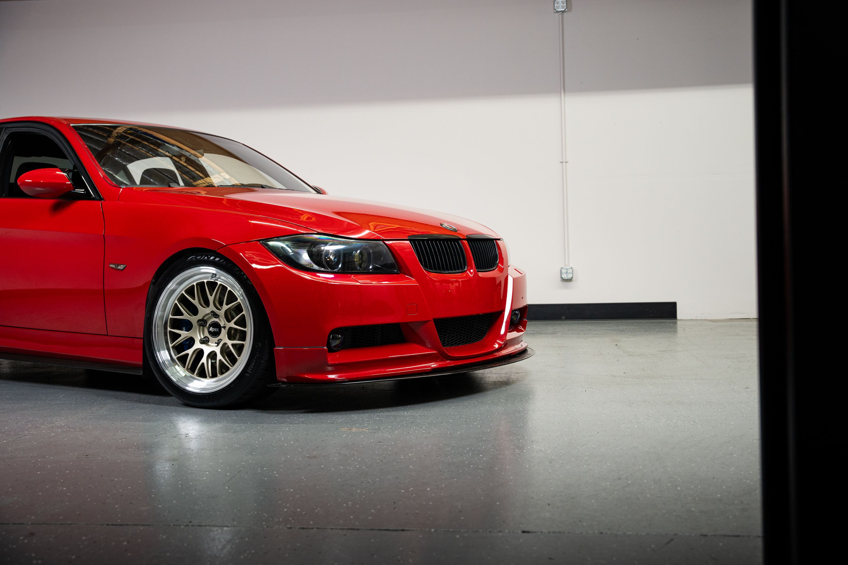 Red BMW E90 Sedan 3 Series with 18" ML-10RT Apex wheels in Machined Lip Gloss Motorsport Gold
