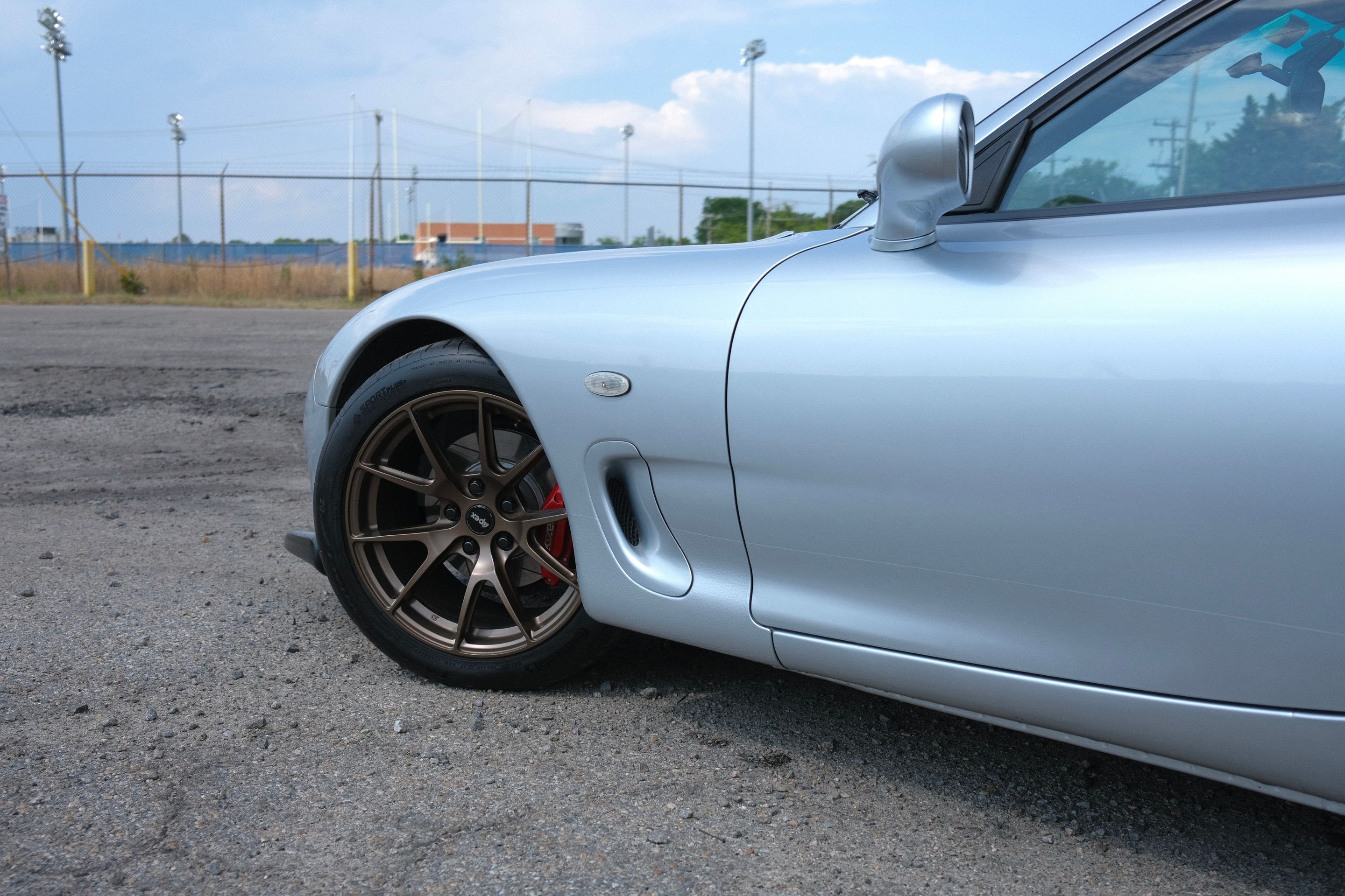 Silver Mazda FD RX-7 with 17" VS-5 Apex wheels in Satin Bronze