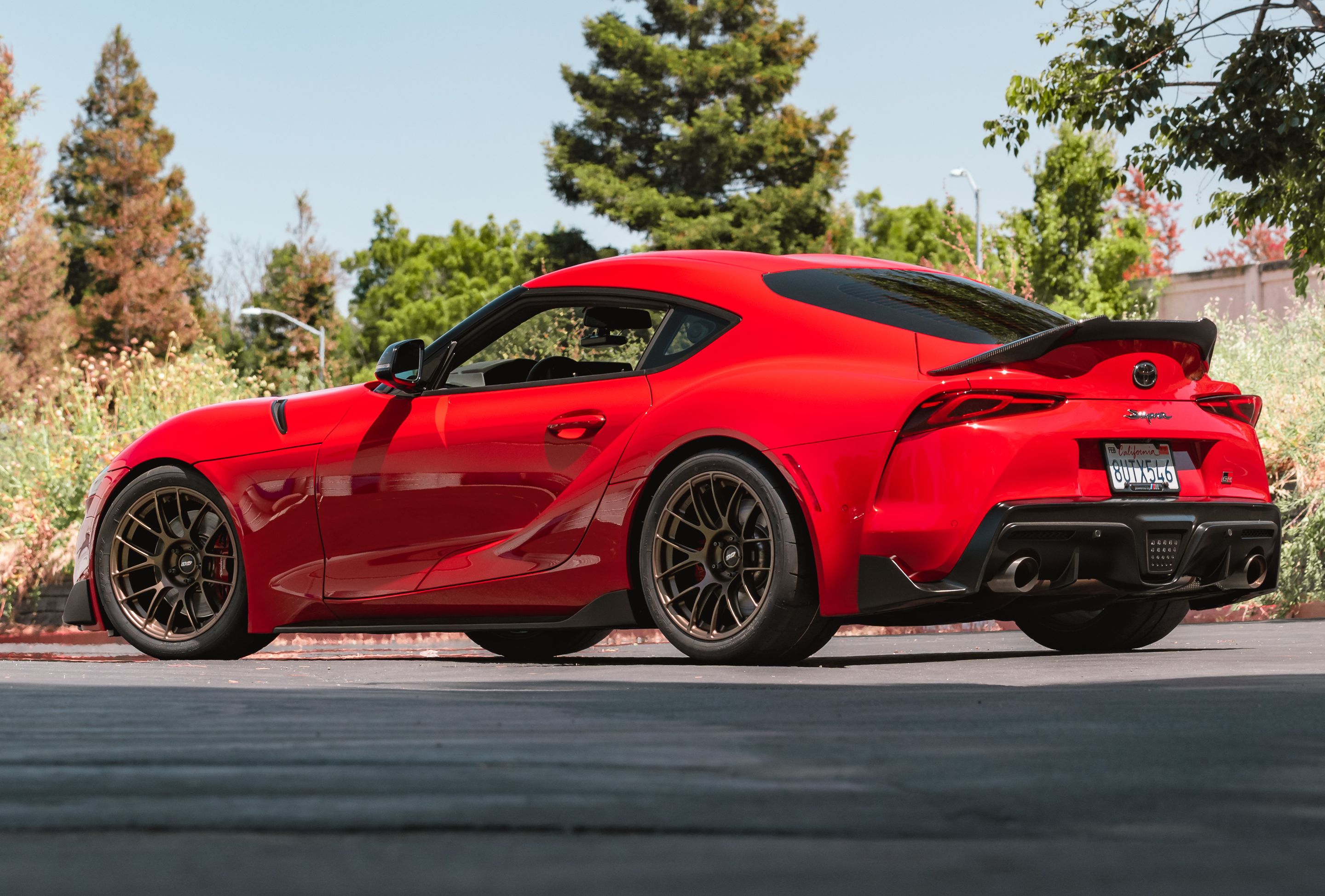 Red Toyota GR Supra with 18" EC-7RS Apex wheels in Satin Bronze
