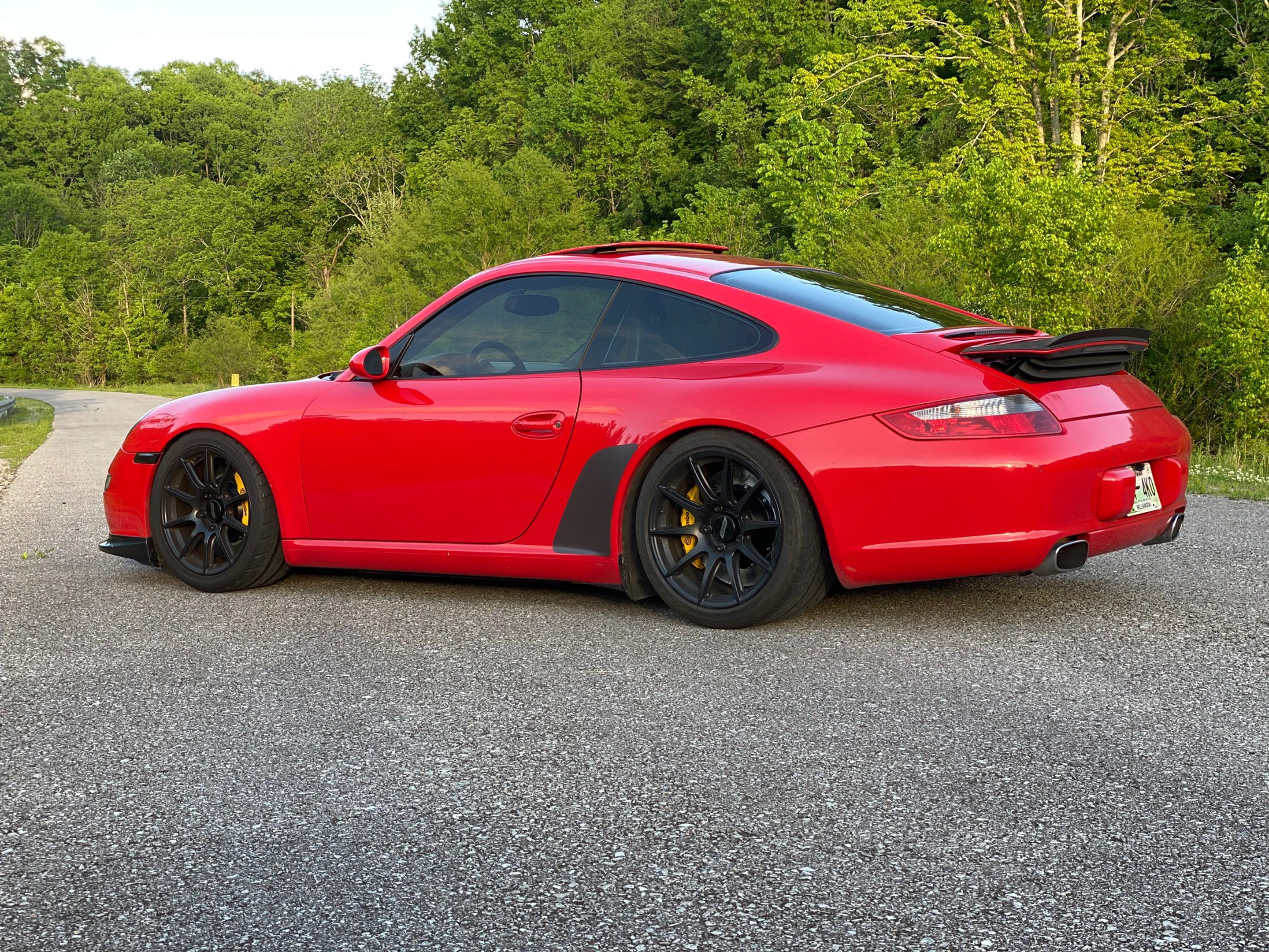 Red Porsche 911 997 Carrera S with 18" SM-10 Apex wheels in Satin Black
