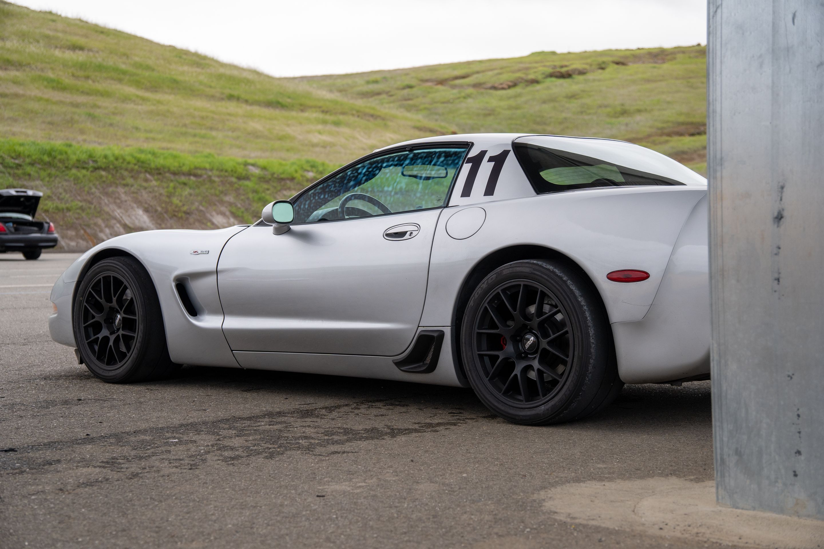 Silver Chevrolet C5 Corvette Z06 with 18" EC-7 Apex wheels in Satin Black