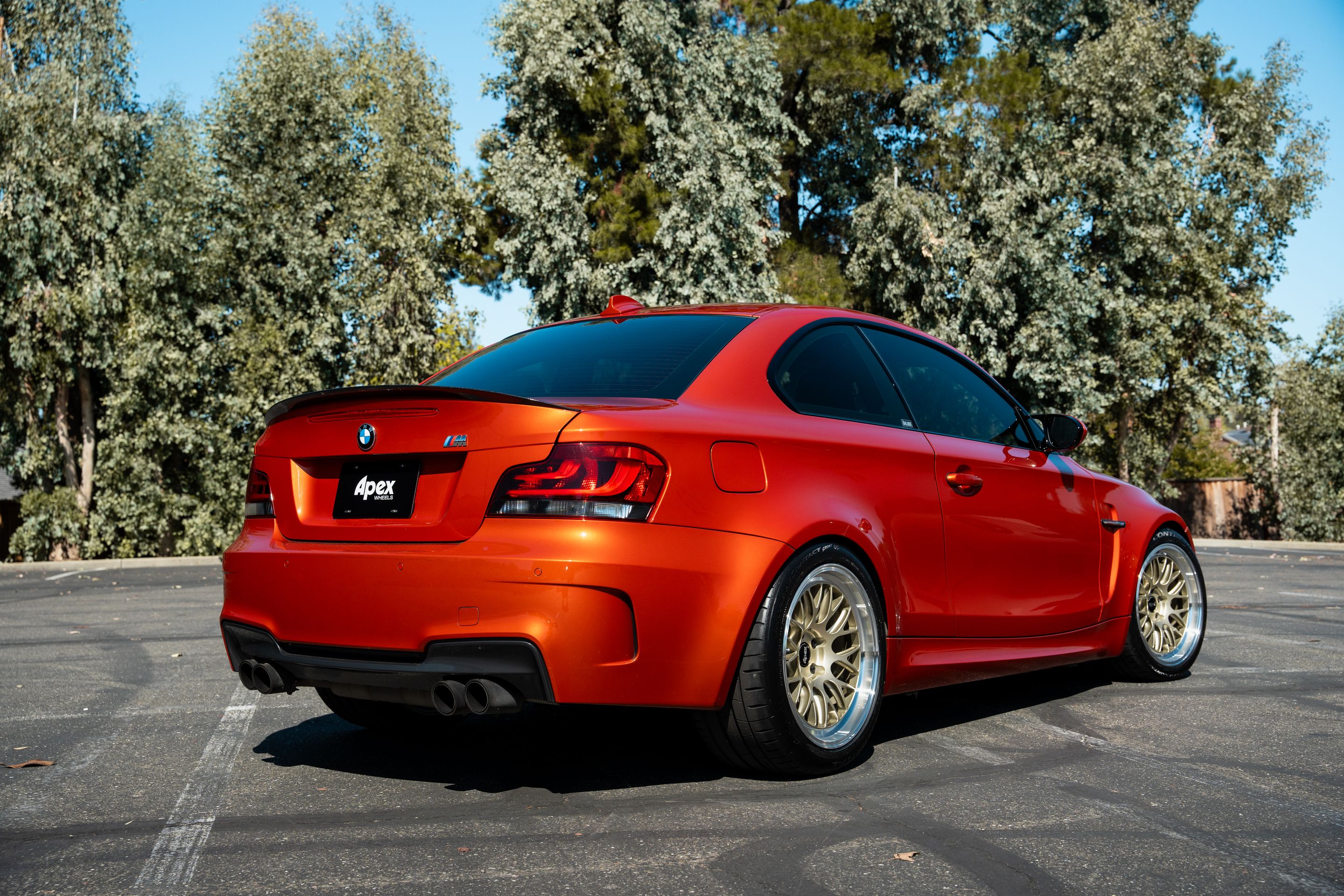 Orange BMW E82 1M with 18" ML-10RT Apex wheels in Machined Lip Gloss Motorsport Gold