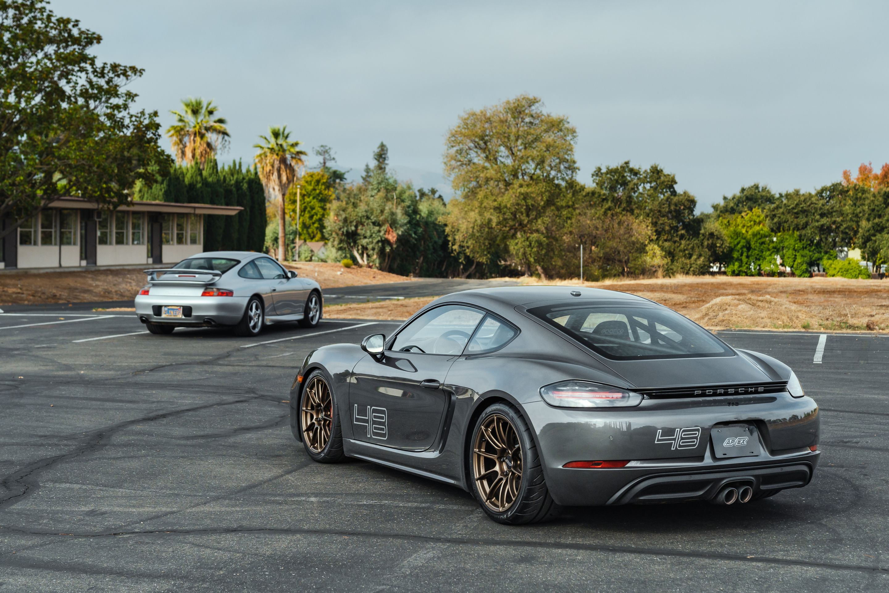 Grey Porsche 718 Cayman S with 19" SM-10RS Apex wheels in Satin Bronze