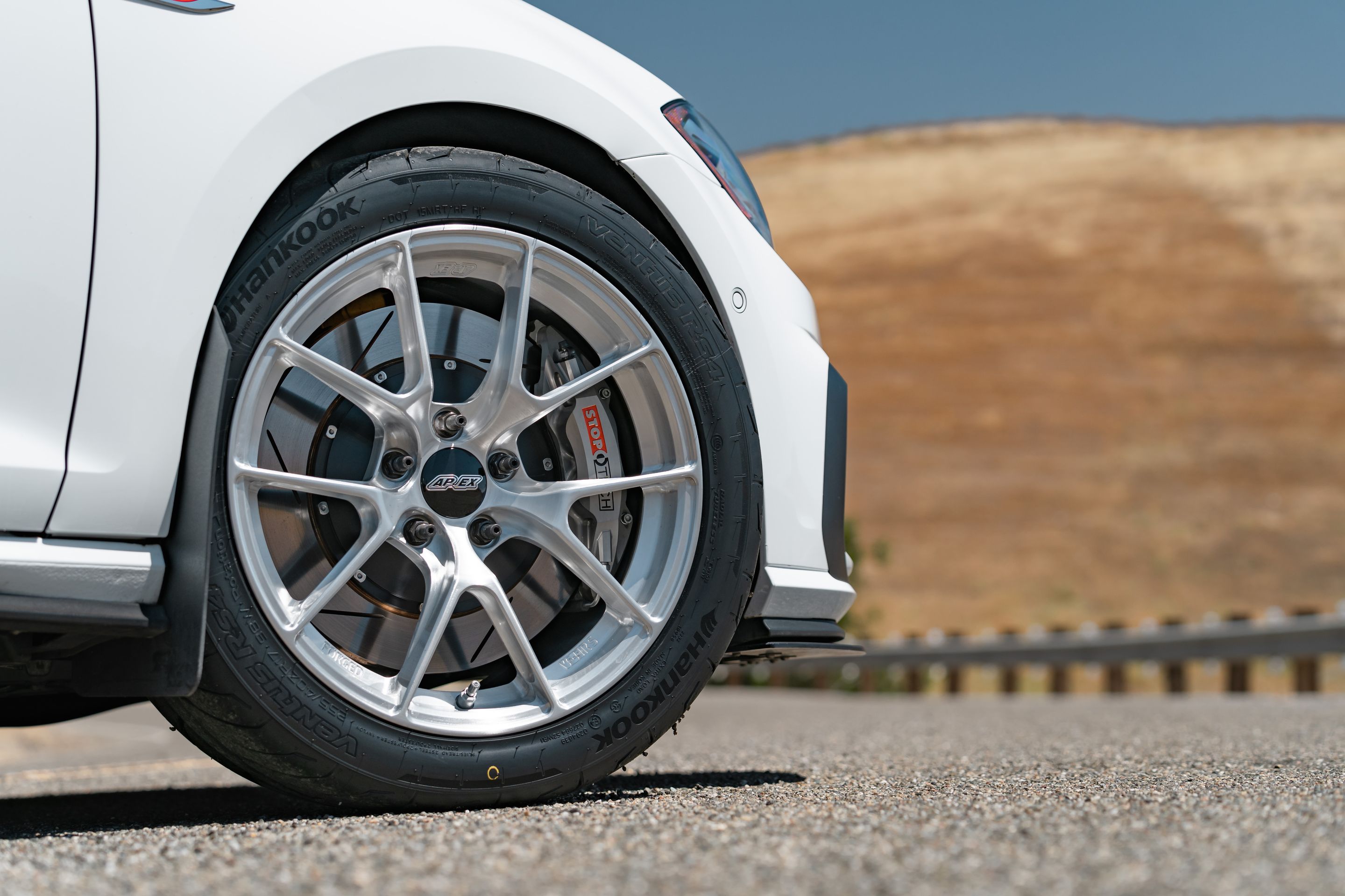 White VW MK7 GTI with 17" VS-5RS Apex wheels in Brushed Clear