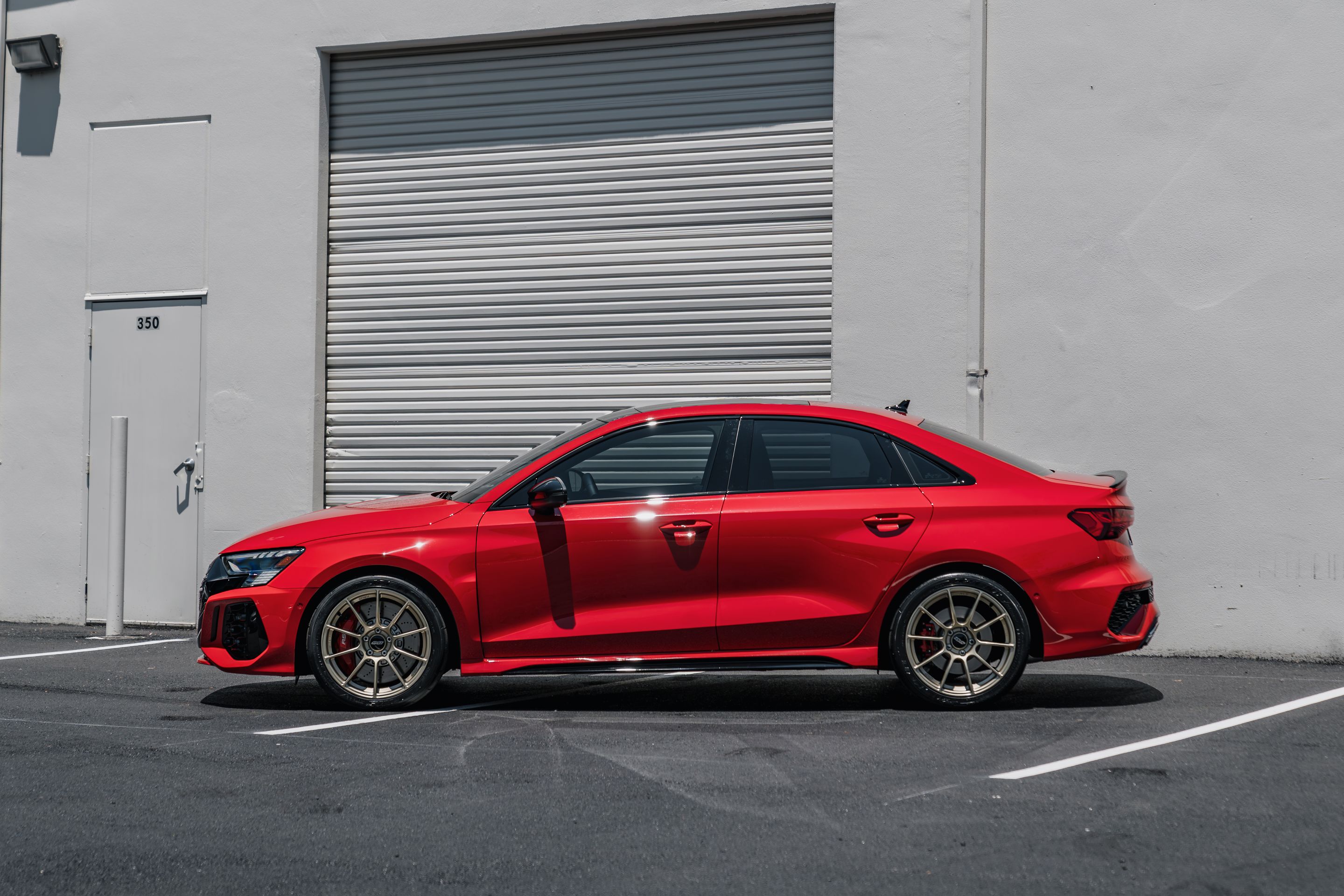 Red Audi 8Y RS 3 with 18" SM-10RS Apex wheels in Motorsport Gold