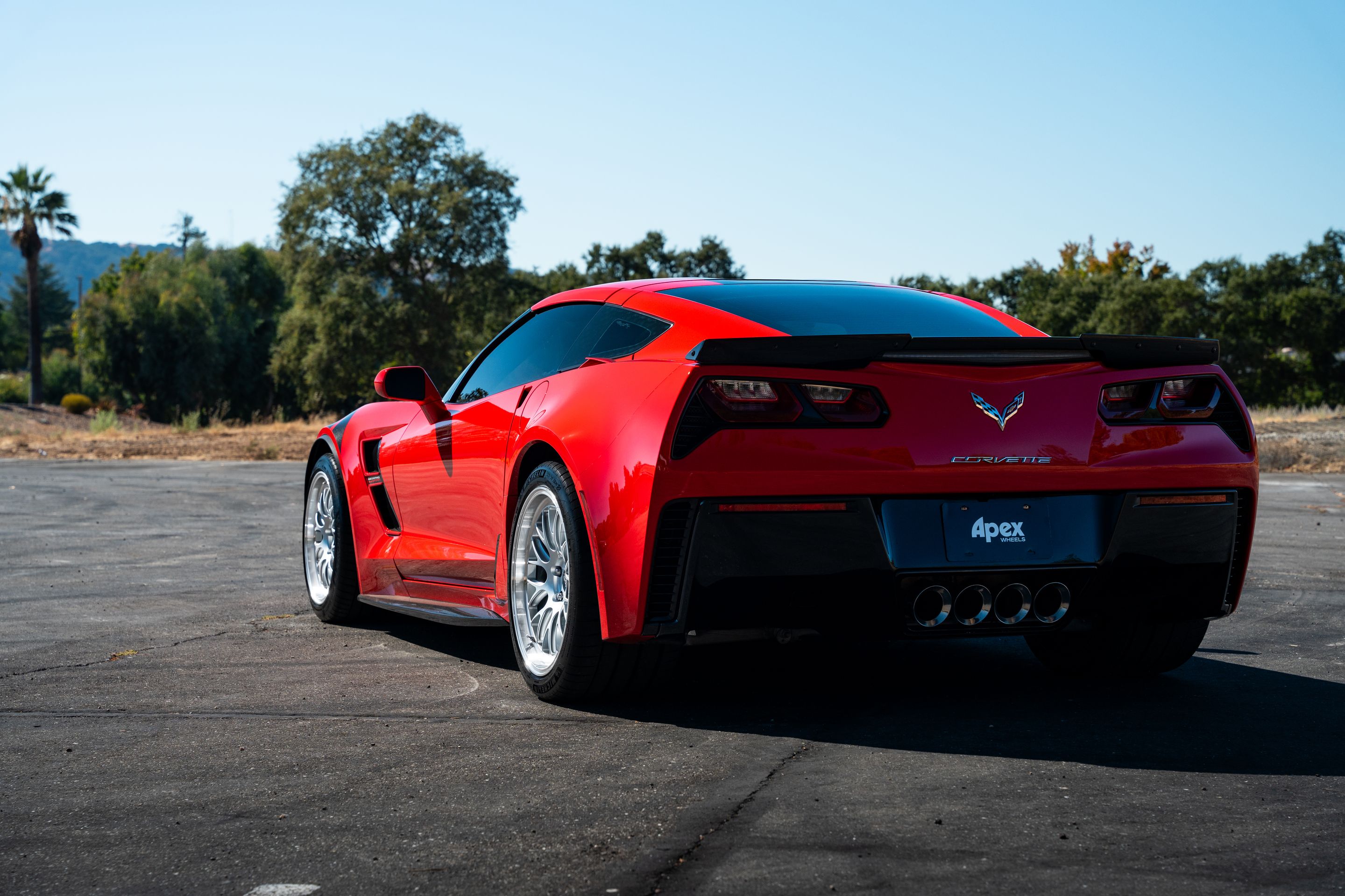 Red Chevrolet C7 Corvette Grand Sport with 18"/19" ML-10RT Apex wheels in Machined Lip Race Silver