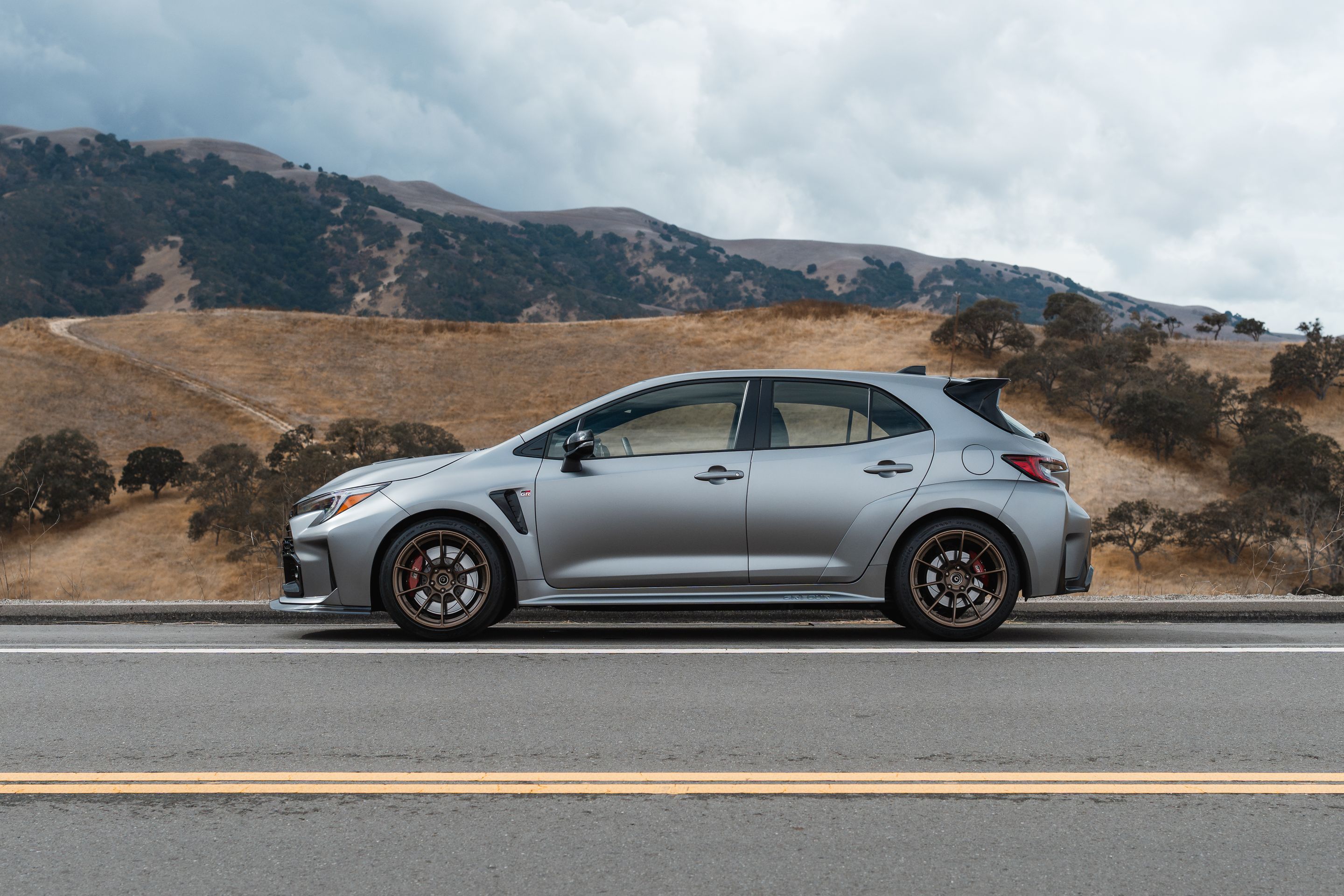 Grey Toyota GR Corolla with 18" SM-10RS Apex wheels in Satin Bronze