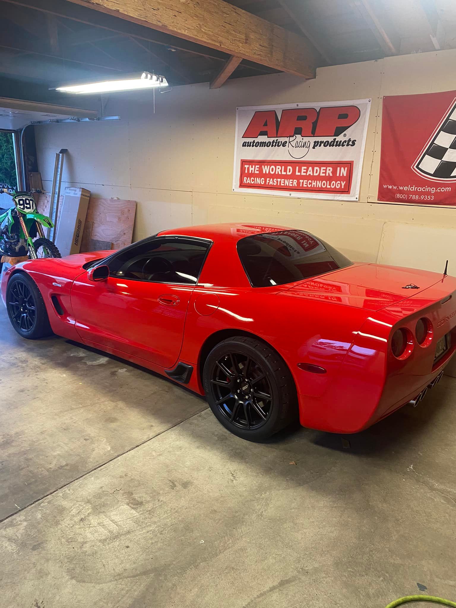 Red Chevrolet C5 Corvette Z06 with 18" SM-10 Apex wheels in Satin Black