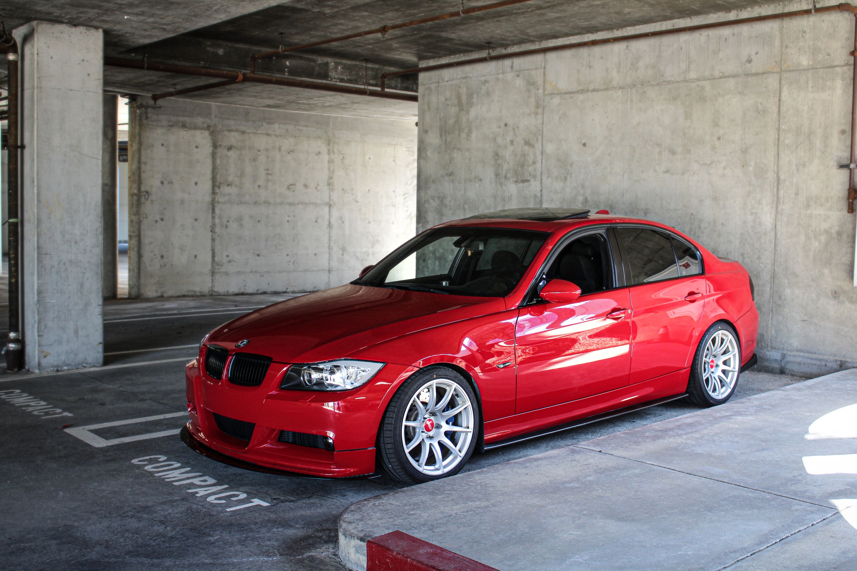 Red BMW E90 Sedan 3 Series with 18" SM-10 Apex wheels in Race Silver
