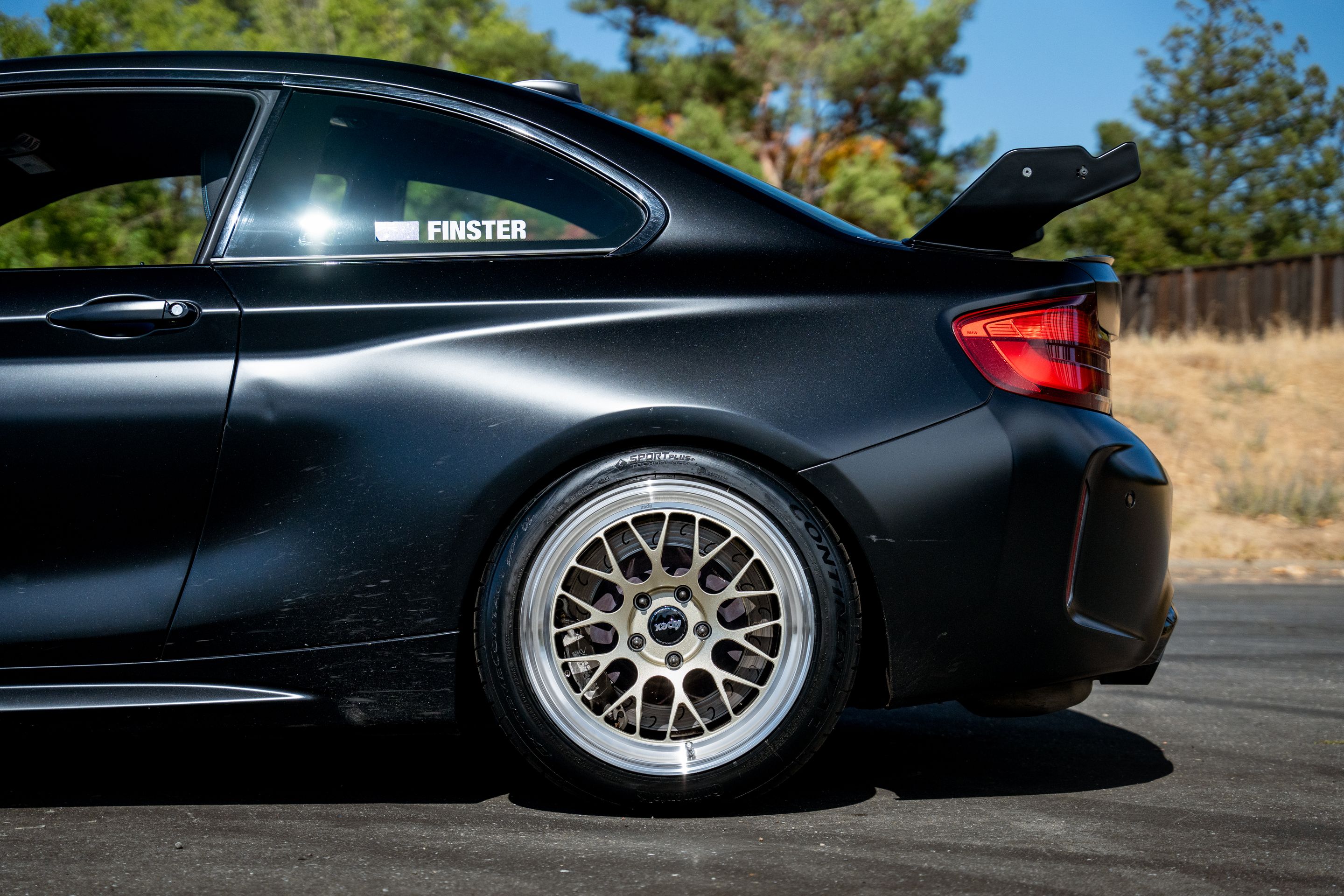 Black BMW F87 M2 with 18" ML-10RT Apex wheels in Machined Lip Gloss Motorsport Gold