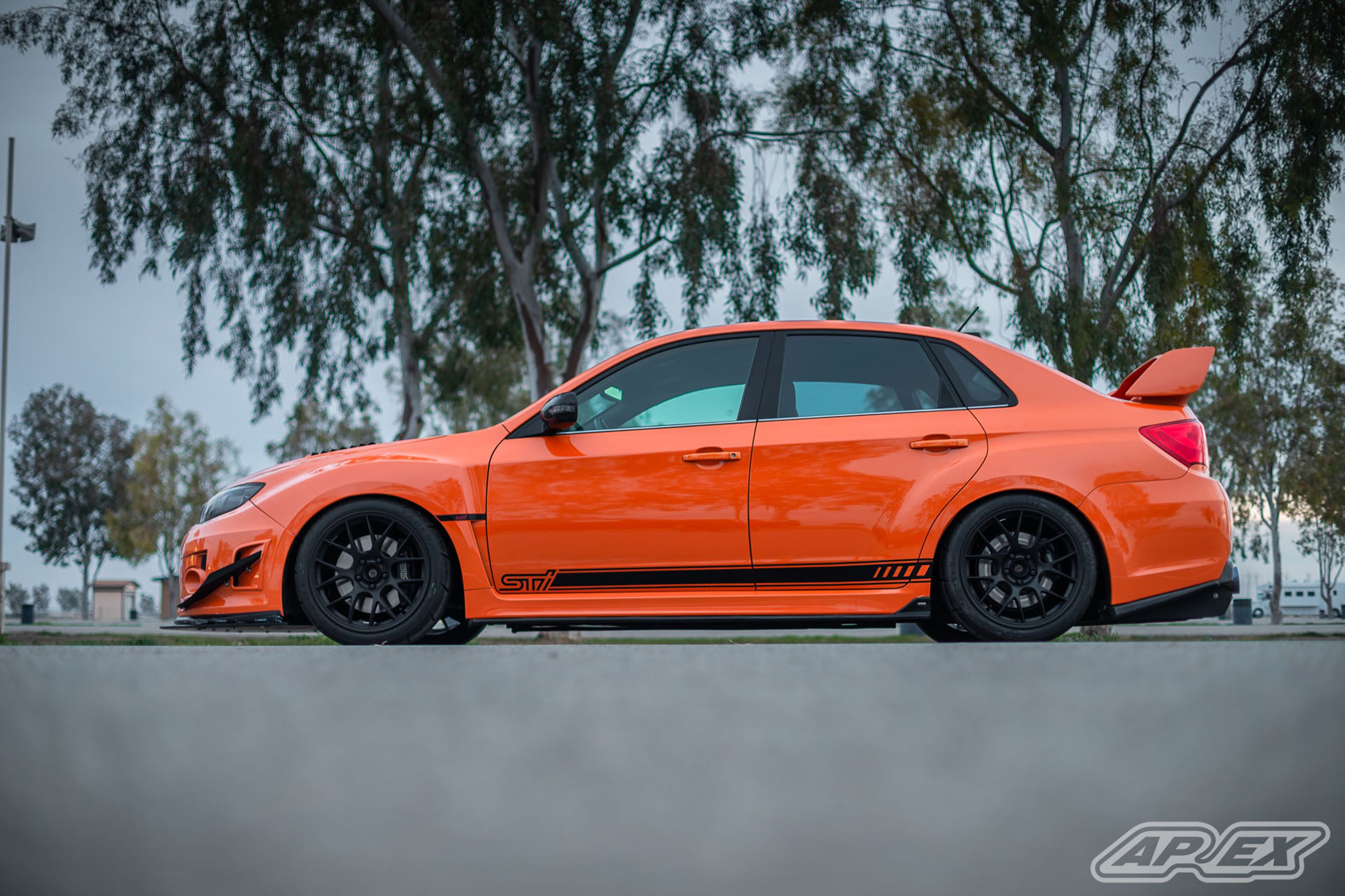 Orange Subaru GR WRX STI with 18" EC-7 Apex wheels in Satin Black