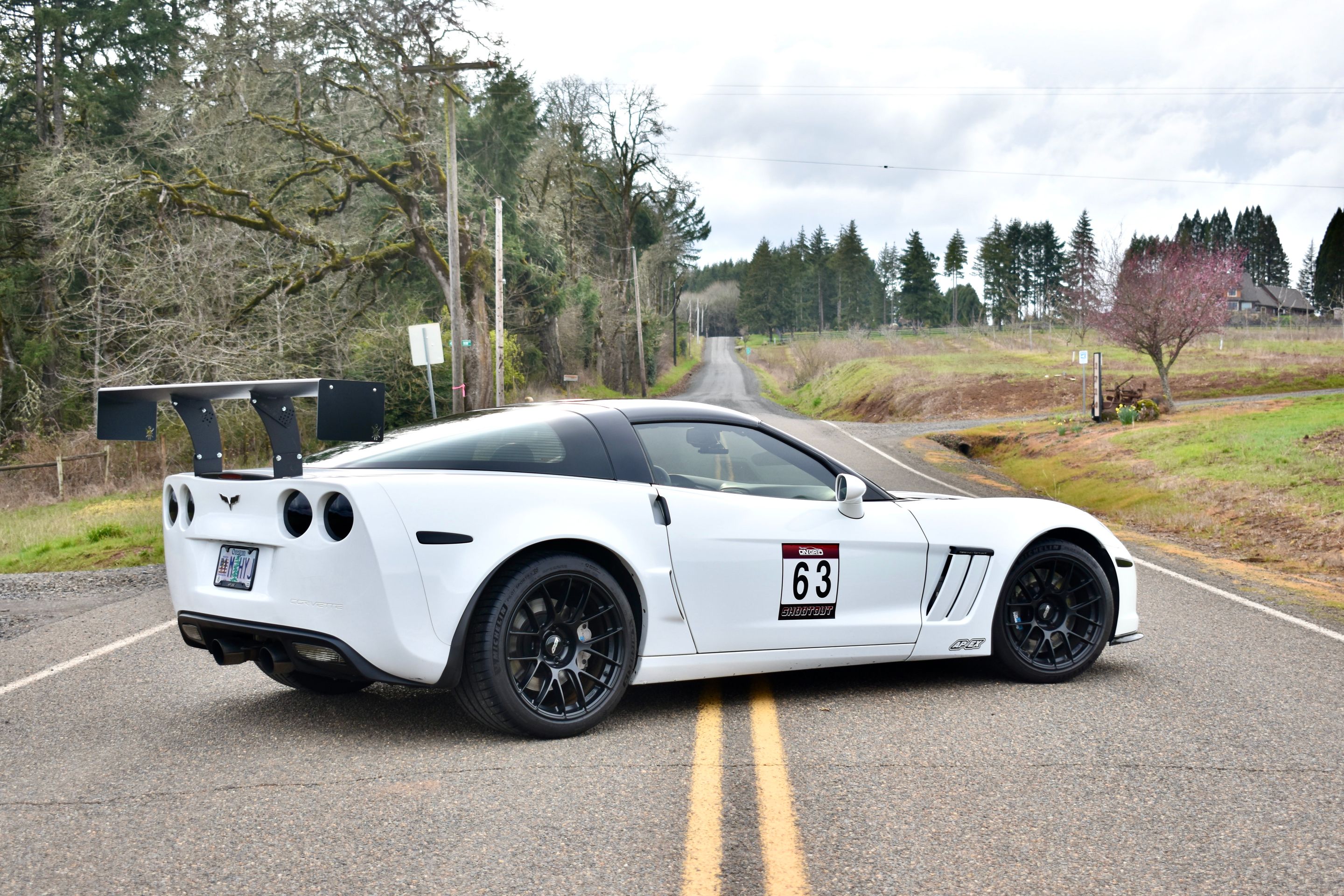 White Chevrolet C6 Corvette Grand Sport with 18"/19" EC-7RS Apex wheels in Satin Black