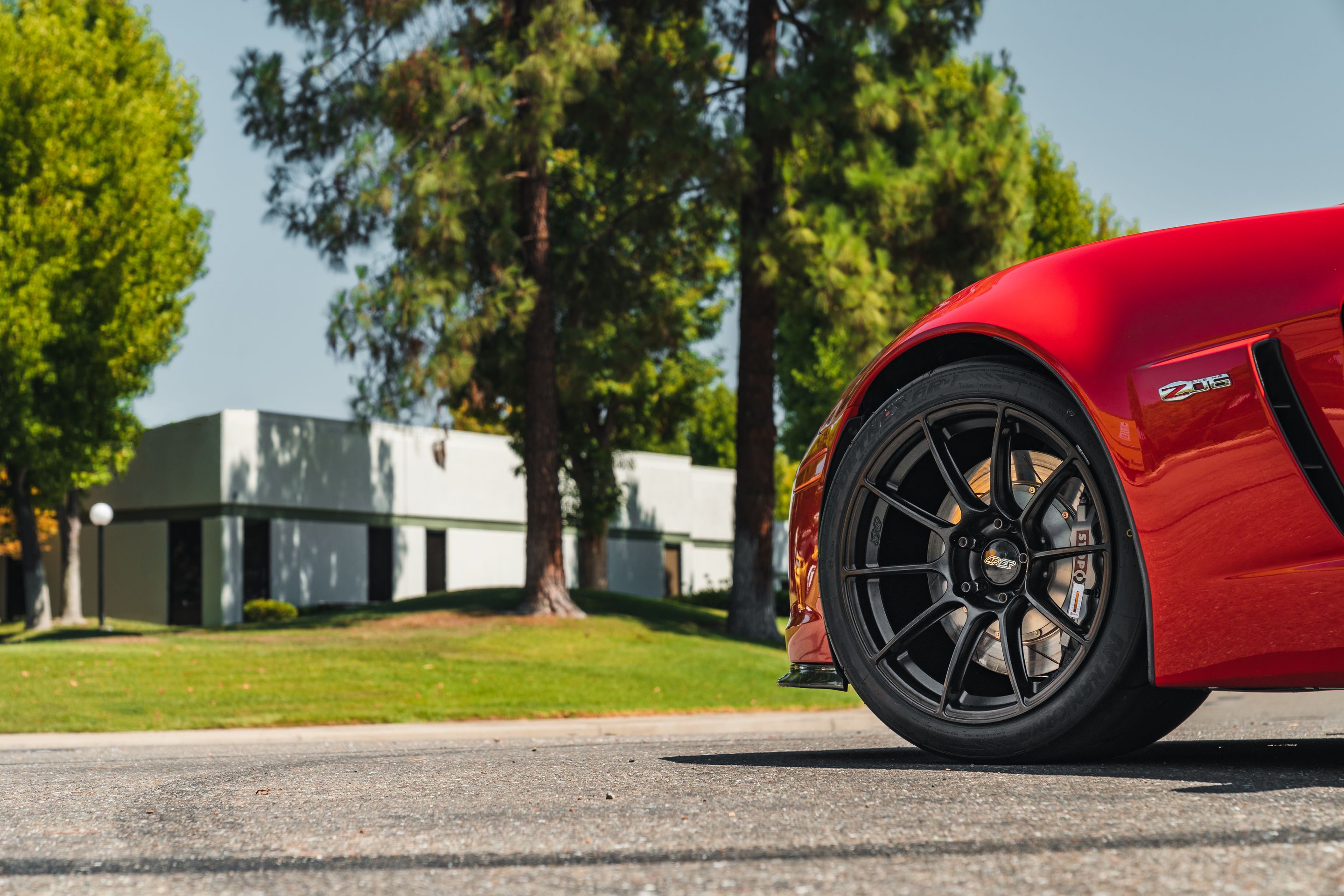 Red Chevrolet C6 Corvette Z06 with 18" SM-10RS Apex wheels in Satin Black