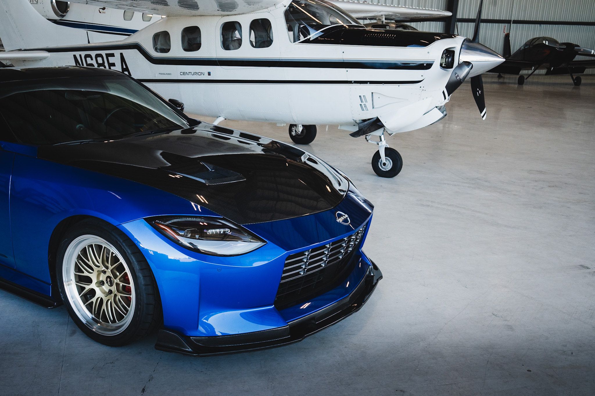 Blue Nissan Z with 19" ML-10RT Apex wheels in Machined Lip Gloss Motorsport Gold