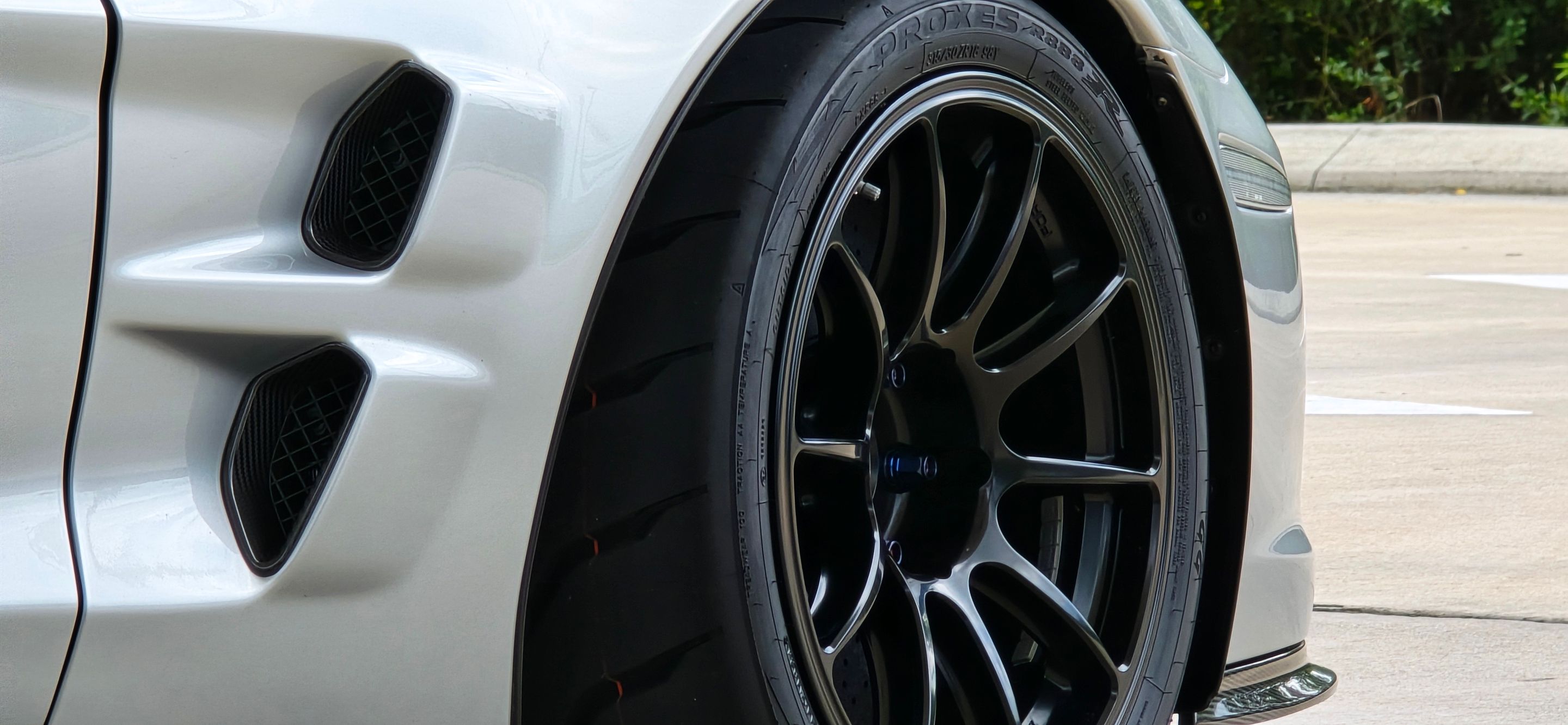 Silver Chevrolet C6 Corvette ZR-1 with 18" SM-10RE Apex wheels in Satin Black