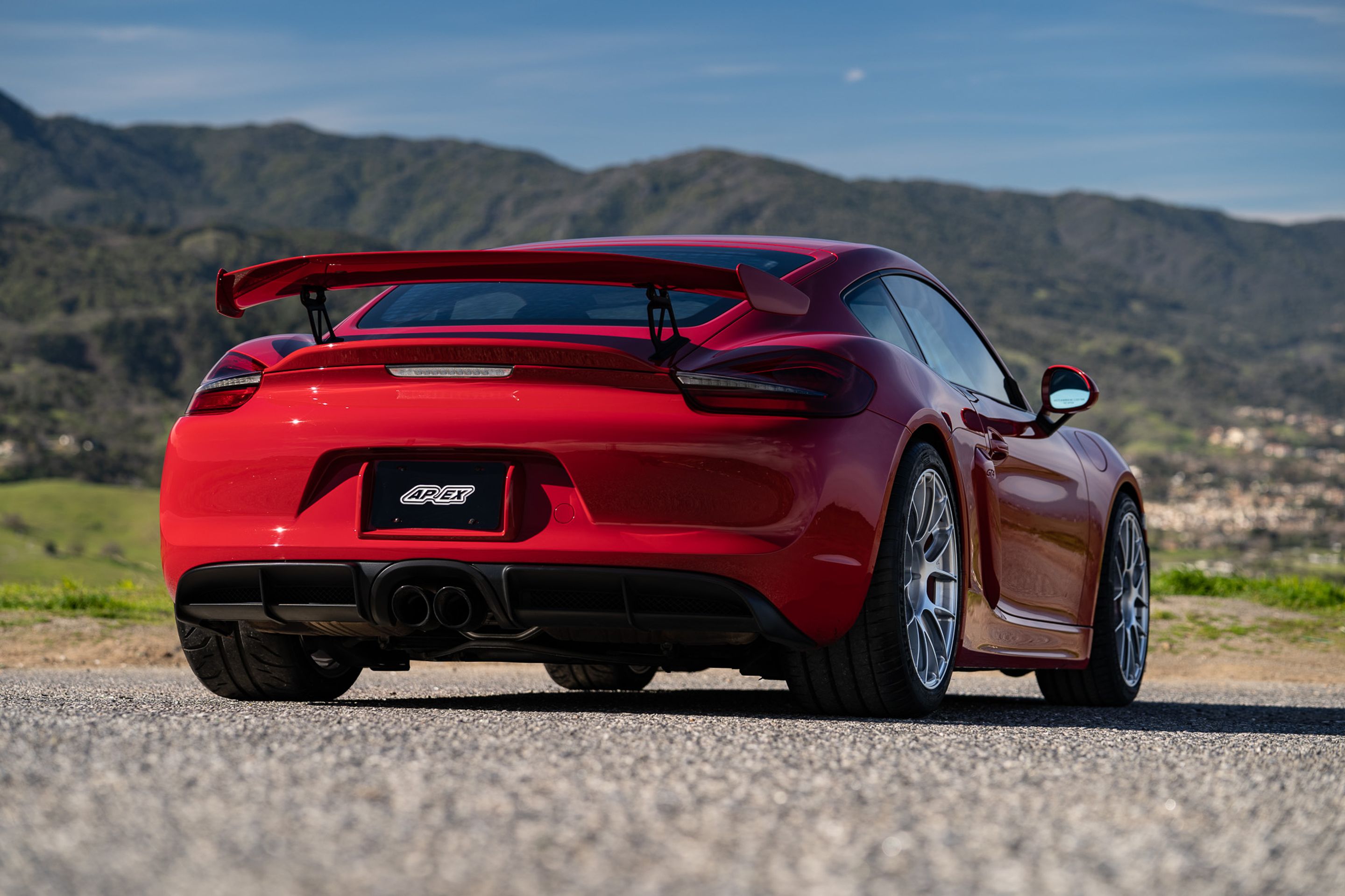 Red Porsche 981 Cayman GT4 with 19" EC-7RS Apex wheels in Race Silver