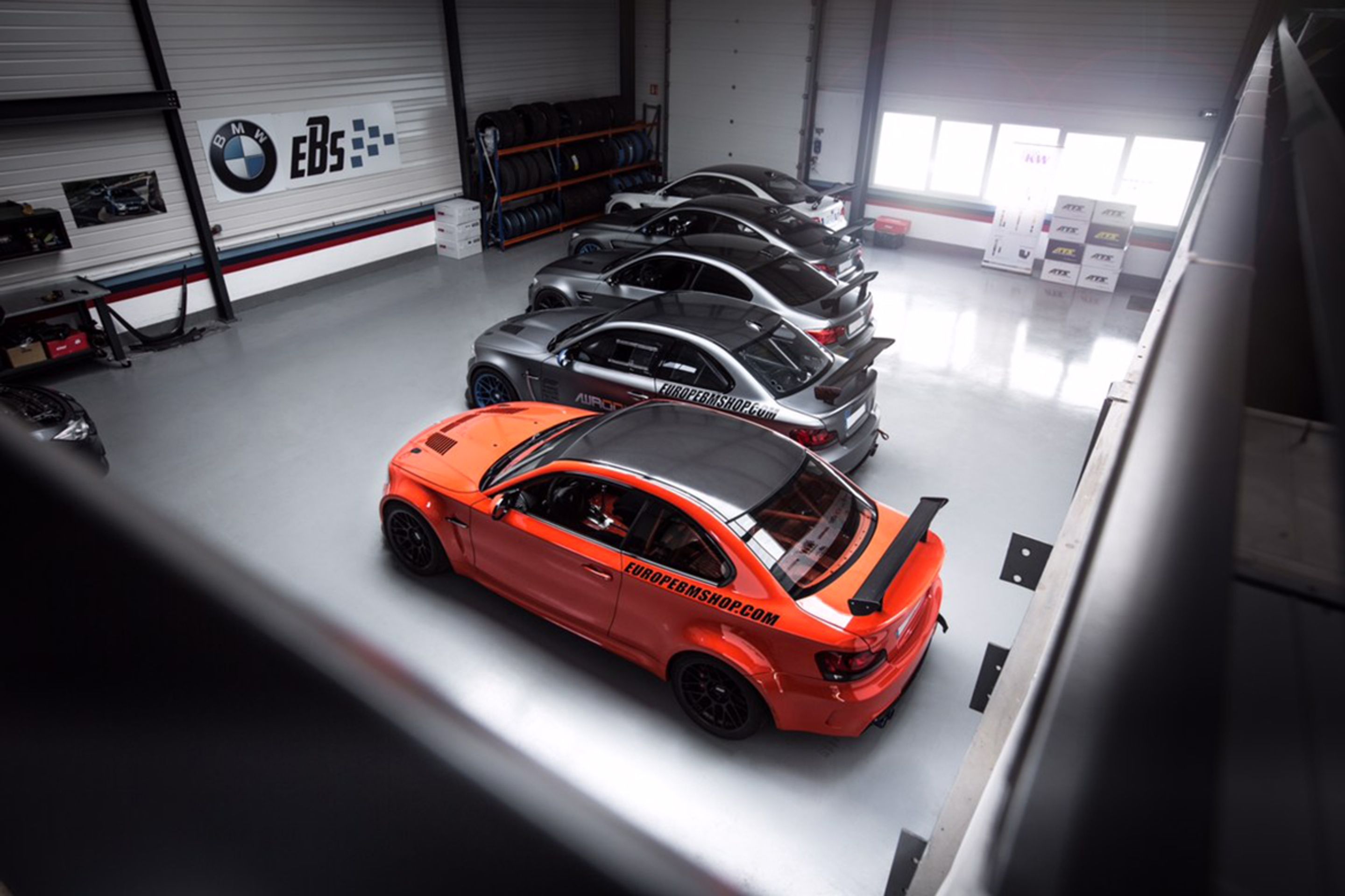 Orange BMW E82 1M with 18" ARC-8 Apex wheels in Satin Black