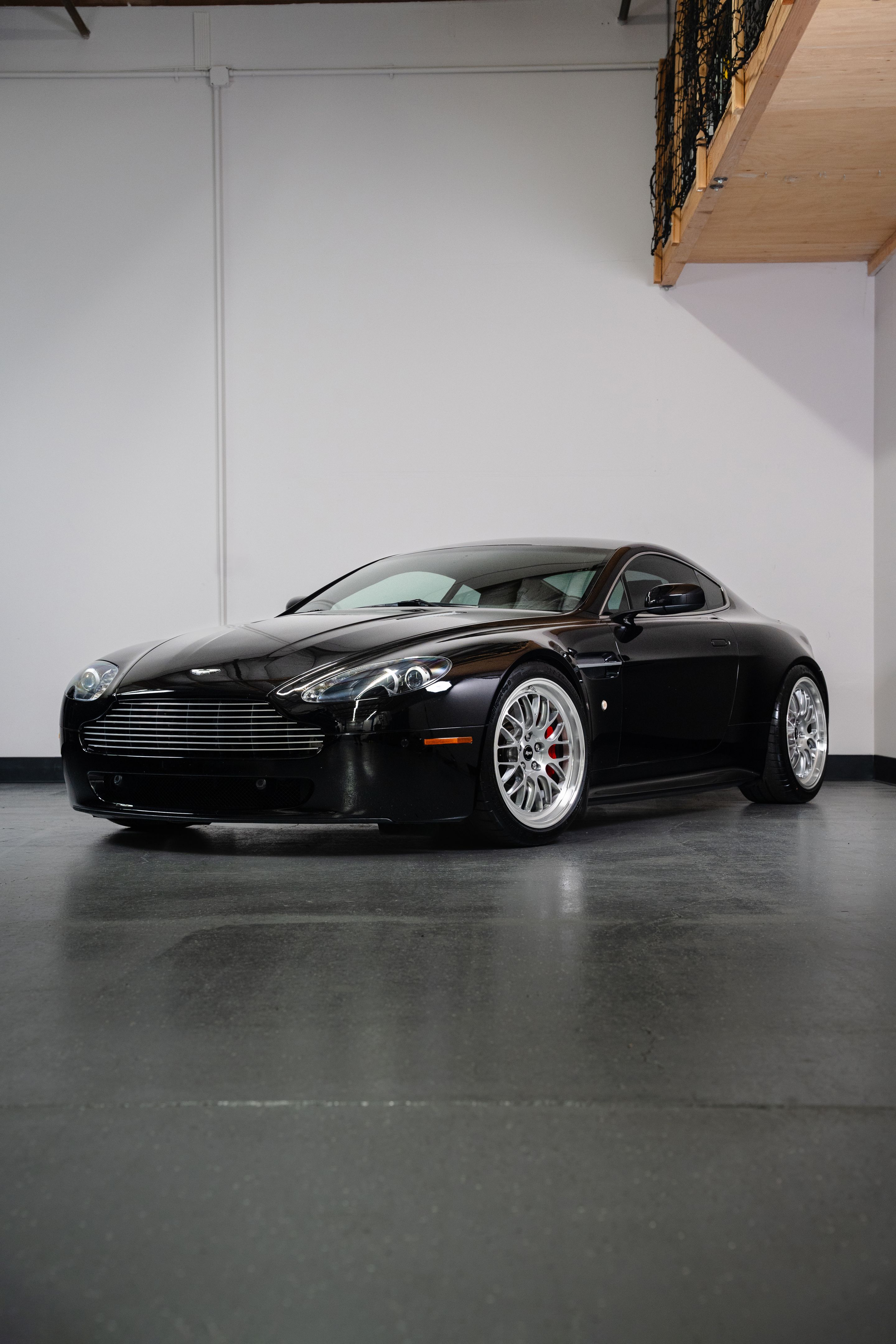 Black Aston Martin V8/V12 Vantage with 19" ML-10RT Apex wheels in Machined Lip Brushed Clear