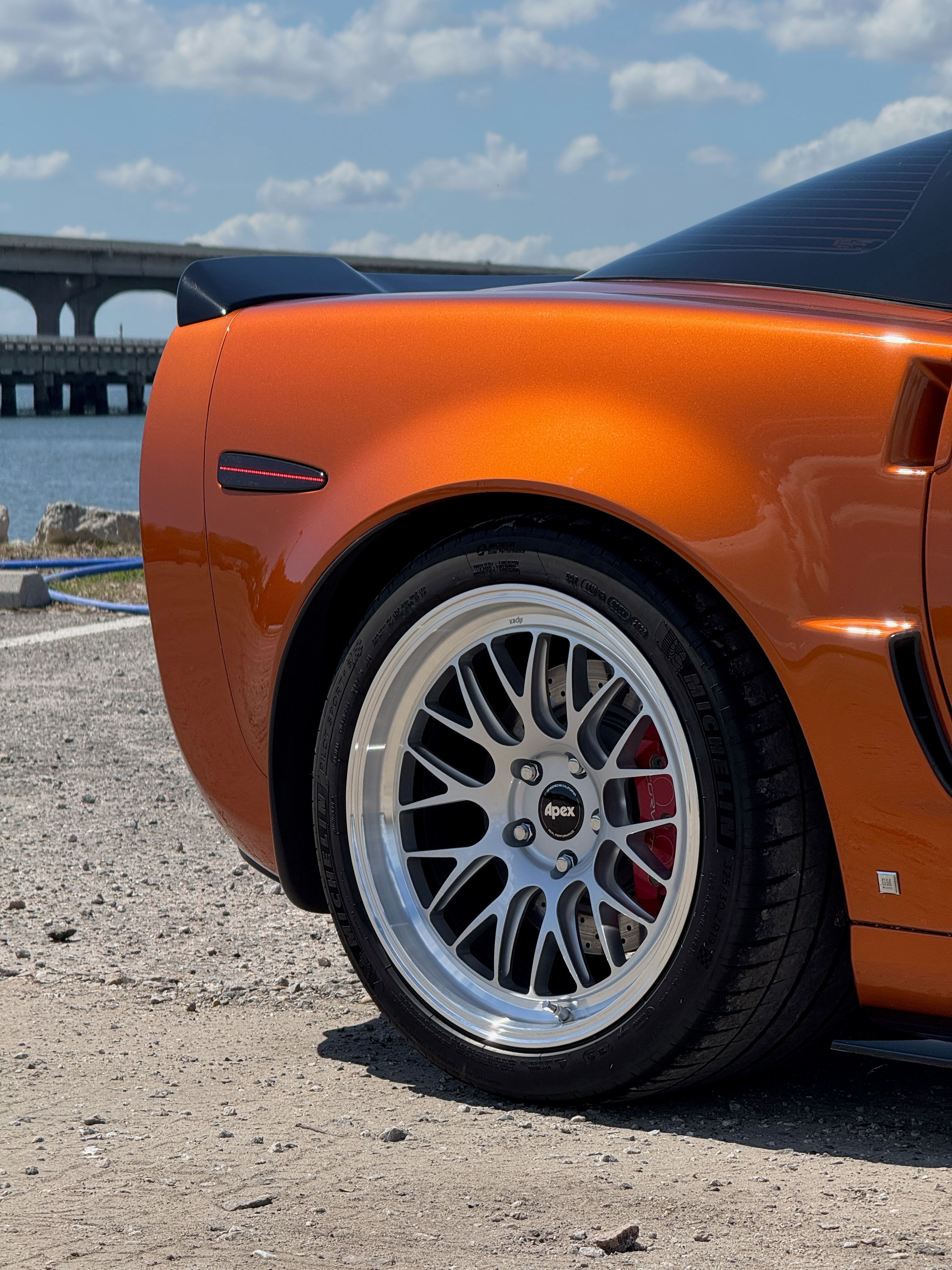 Orange Chevrolet C6 Corvette Z06 with 18"/19" ML-10RT Apex wheels in Machined Lip Race Silver