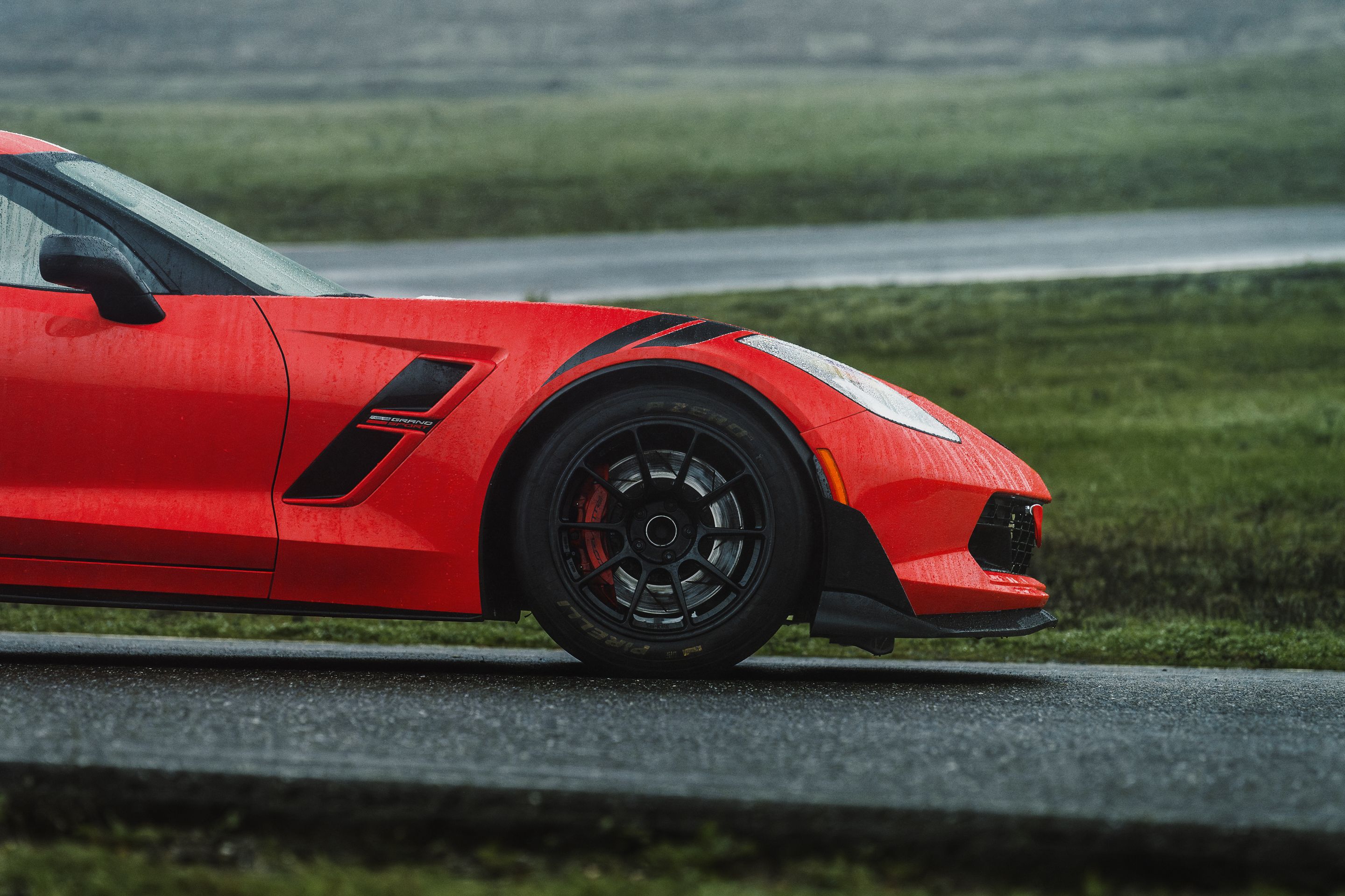 Red Chevrolet C7 Corvette Grand Sport with 18" SM-10RE Apex wheels in Satin Black