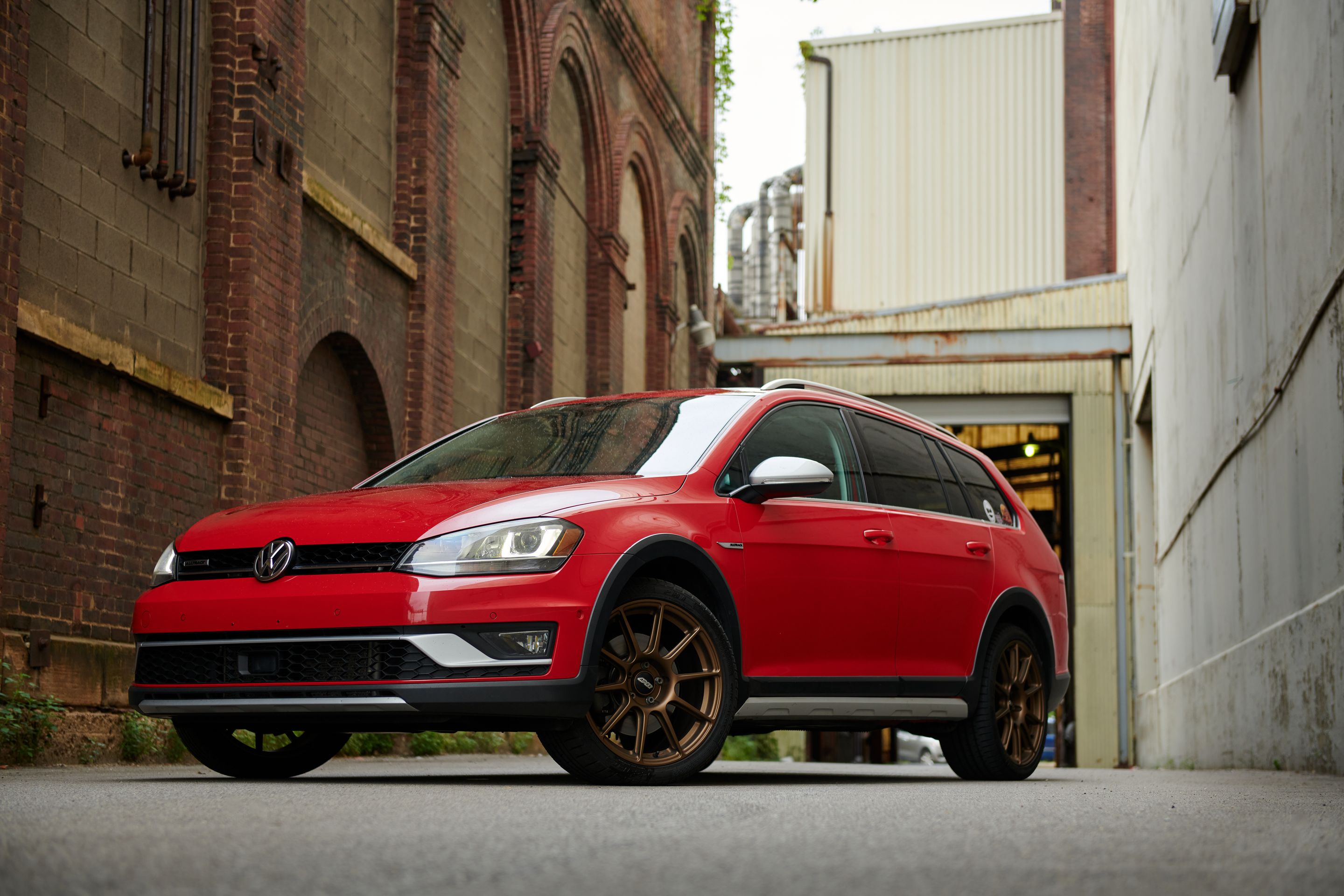 Red VW MK7 Alltrack/SportWagen Alltrack with 18" SM-10 Apex wheels in Satin Bronze