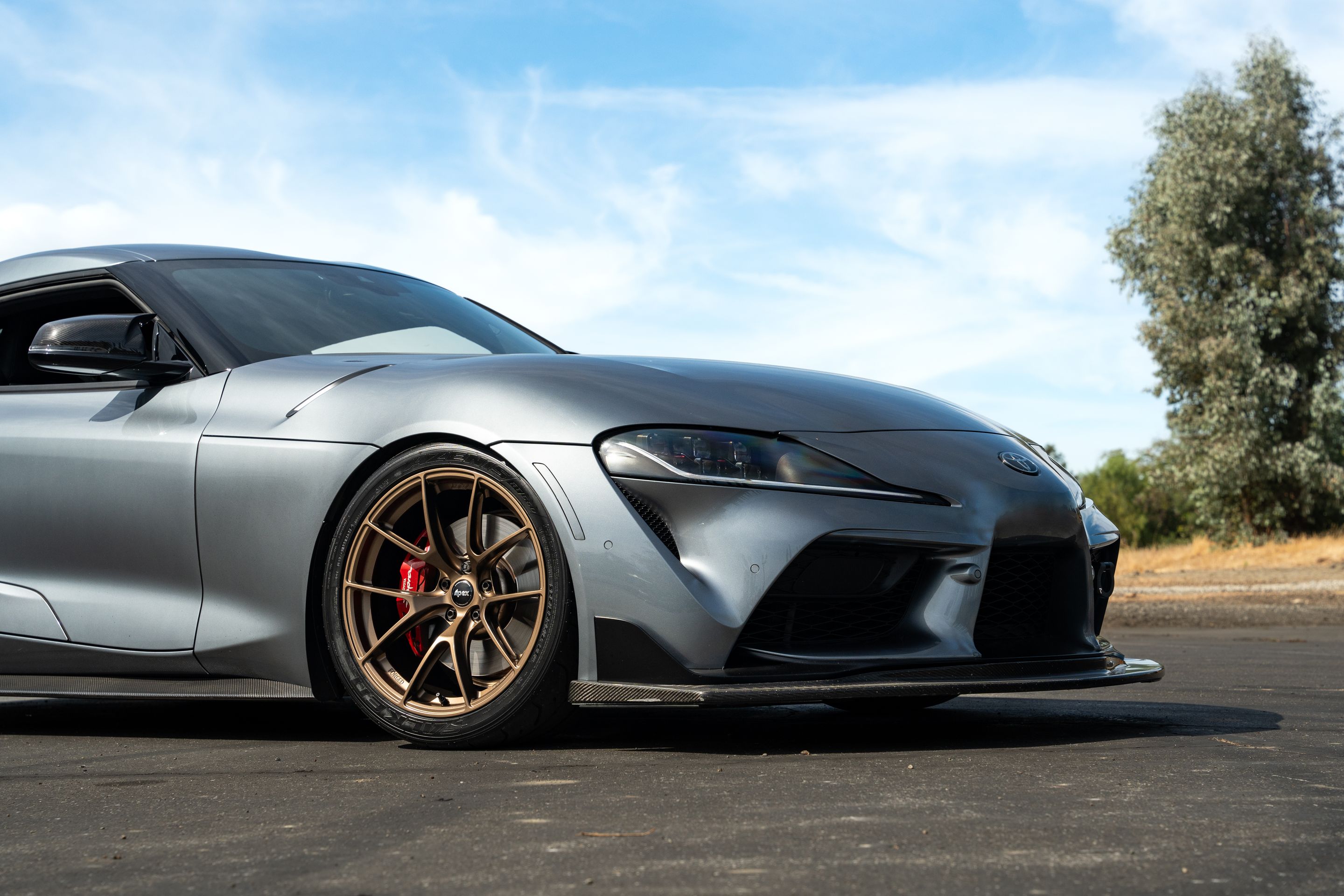 Grey Toyota GR Supra with 19" VS-5RS Apex wheels in Satin Bronze