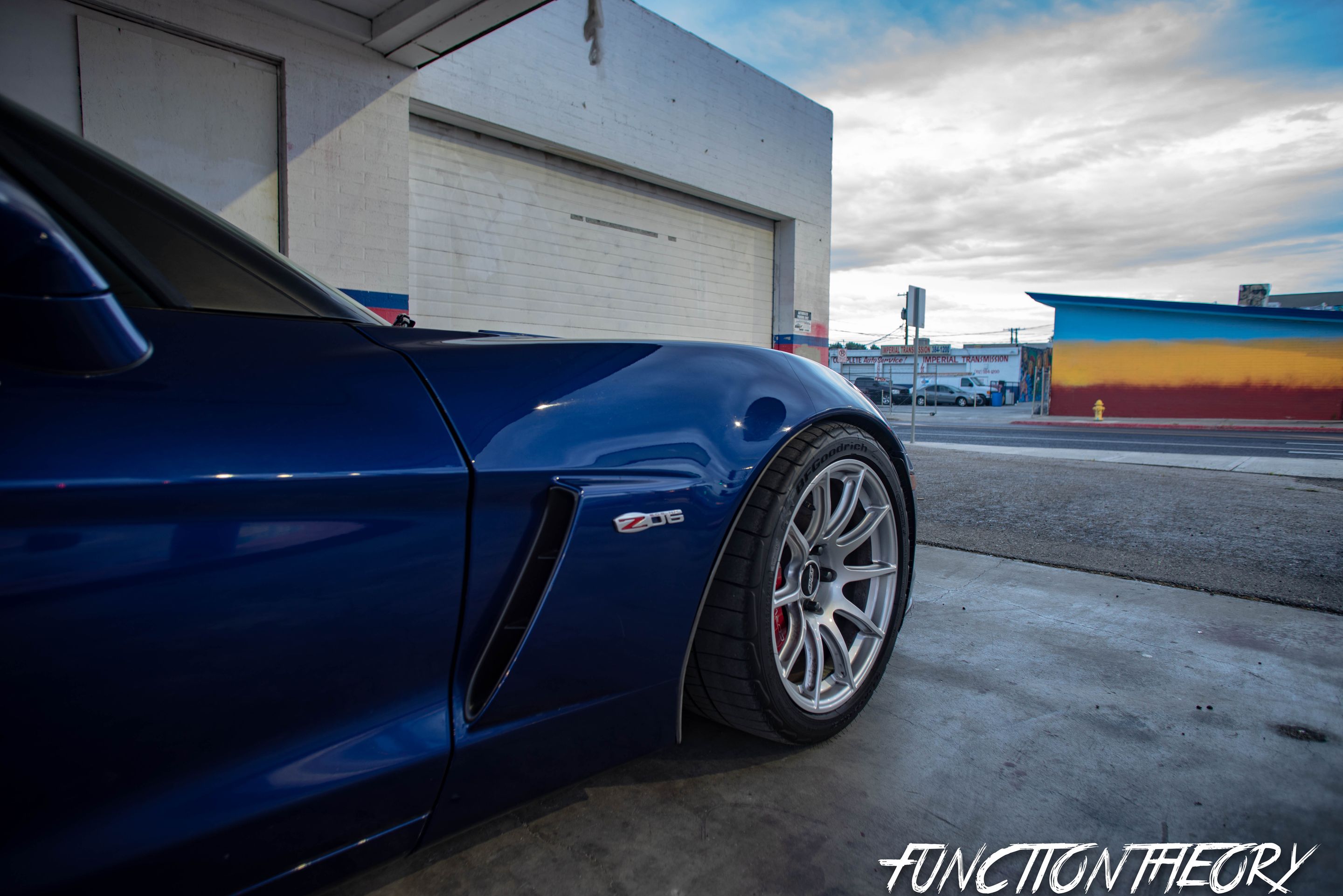 Blue Chevrolet C6 Corvette Z06 with 18" SM-10 Apex wheels in Race Silver