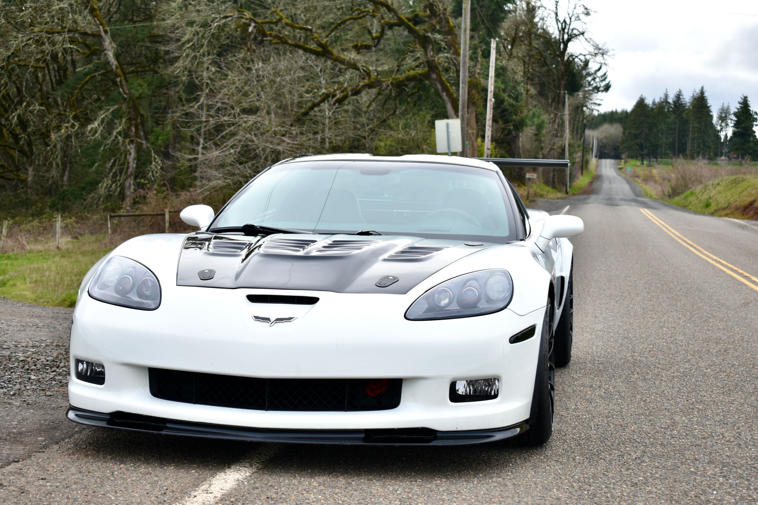 White Chevrolet C6 Corvette Grand Sport with 18"/19" EC-7RS Apex wheels in Satin Black