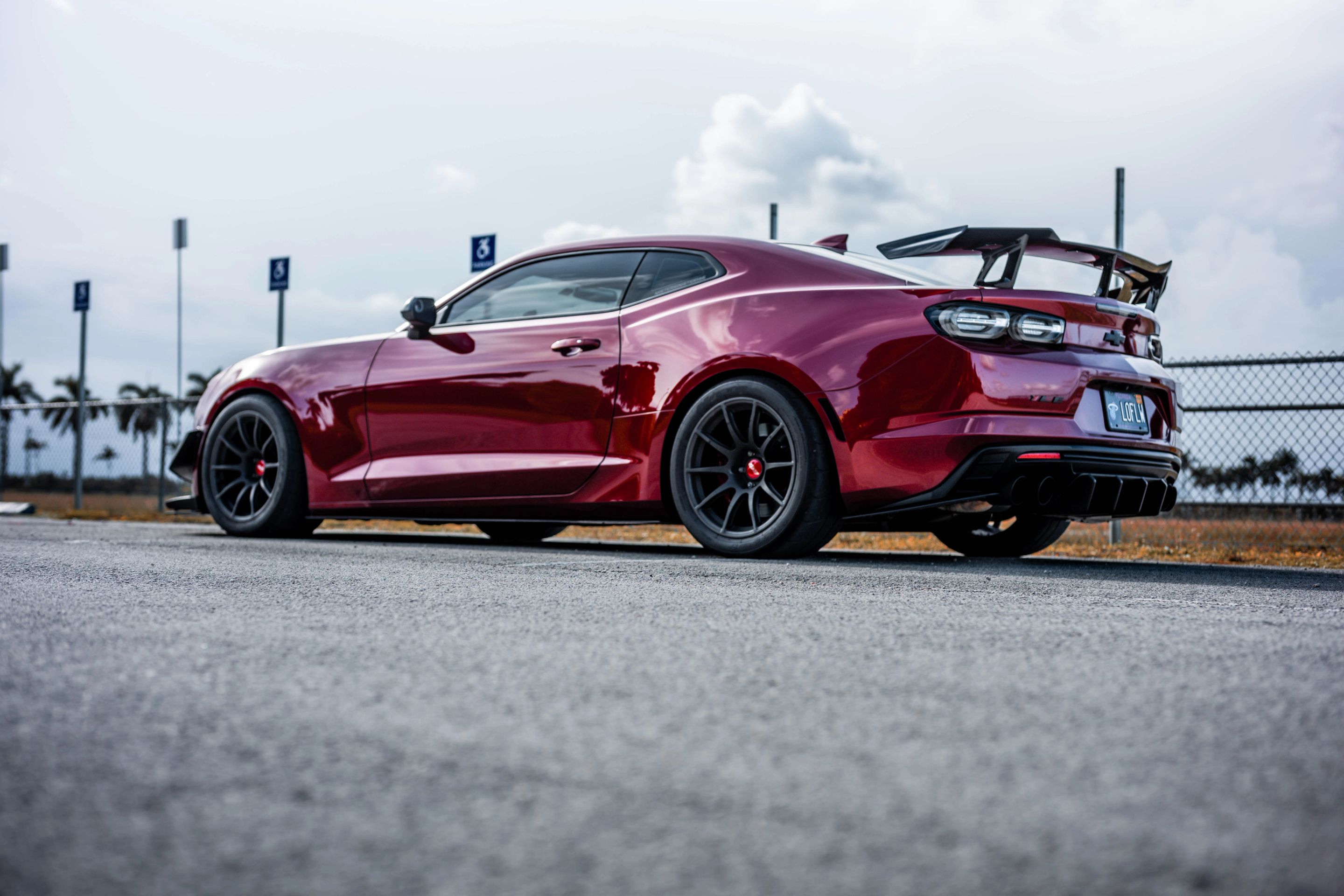 Red Chevrolet 6th Gen Camaro SS with 19" SM-10 Apex wheels in Satin Black