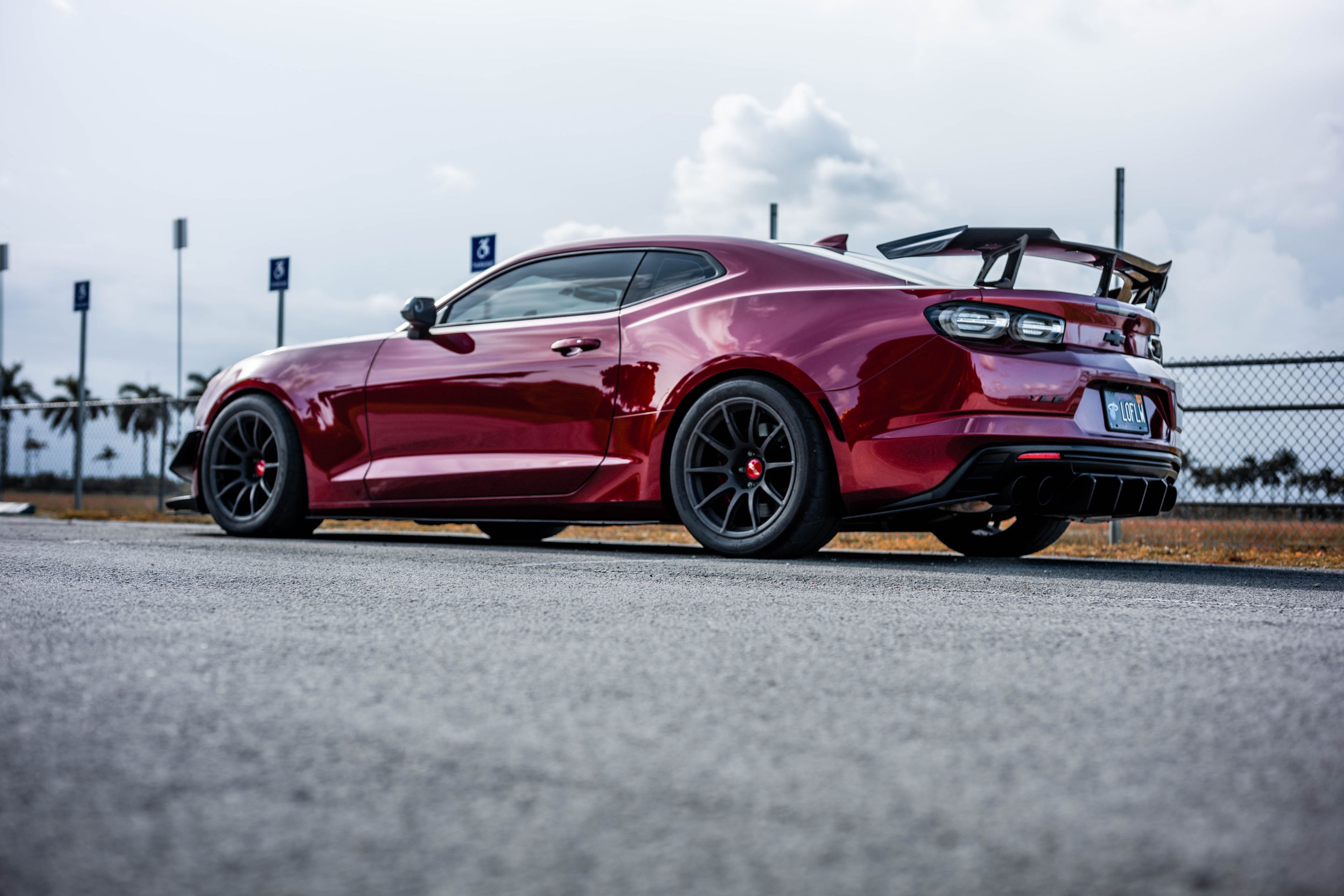 Red Chevrolet 6th Gen Camaro SS with 19" SM-10 Apex wheels in Satin Black
